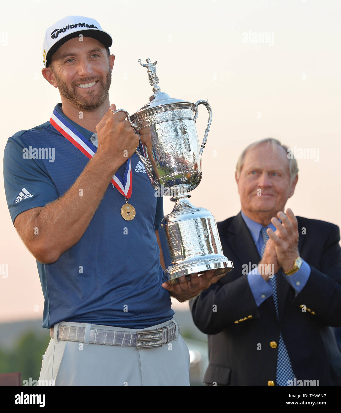 La leggenda del Golf Jack Nicklaus applaude come Dustin Johnson detiene il Campionato trofeo su xviii verde dopo aver vinto il suo primo campionato importante nel round finale presso l'U.S. Aperto a Oakmont Country Club vicino Pittsburgh, Pensilvania il 19 giugno 2016. Johnson ha vinto con un punteggio di 5 sotto il par. Foto di Kevin Dietsch/UPI Foto Stock