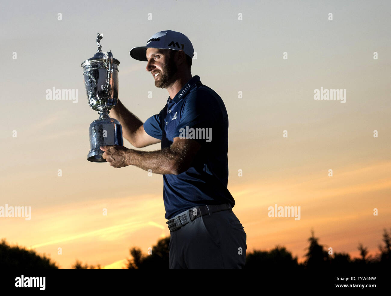 Dustin Johnson detiene il Campionato trofeo su xviii verde dopo aver vinto il suo primo campionato importante nel round finale presso l'U.S. Aperto a Oakmont Country Club vicino Pittsburgh, Pensilvania il 19 giugno 2016. Johnson ha vinto con un punteggio di 5 sotto il par. Foto di Kevin Dietsch/UPI Foto Stock