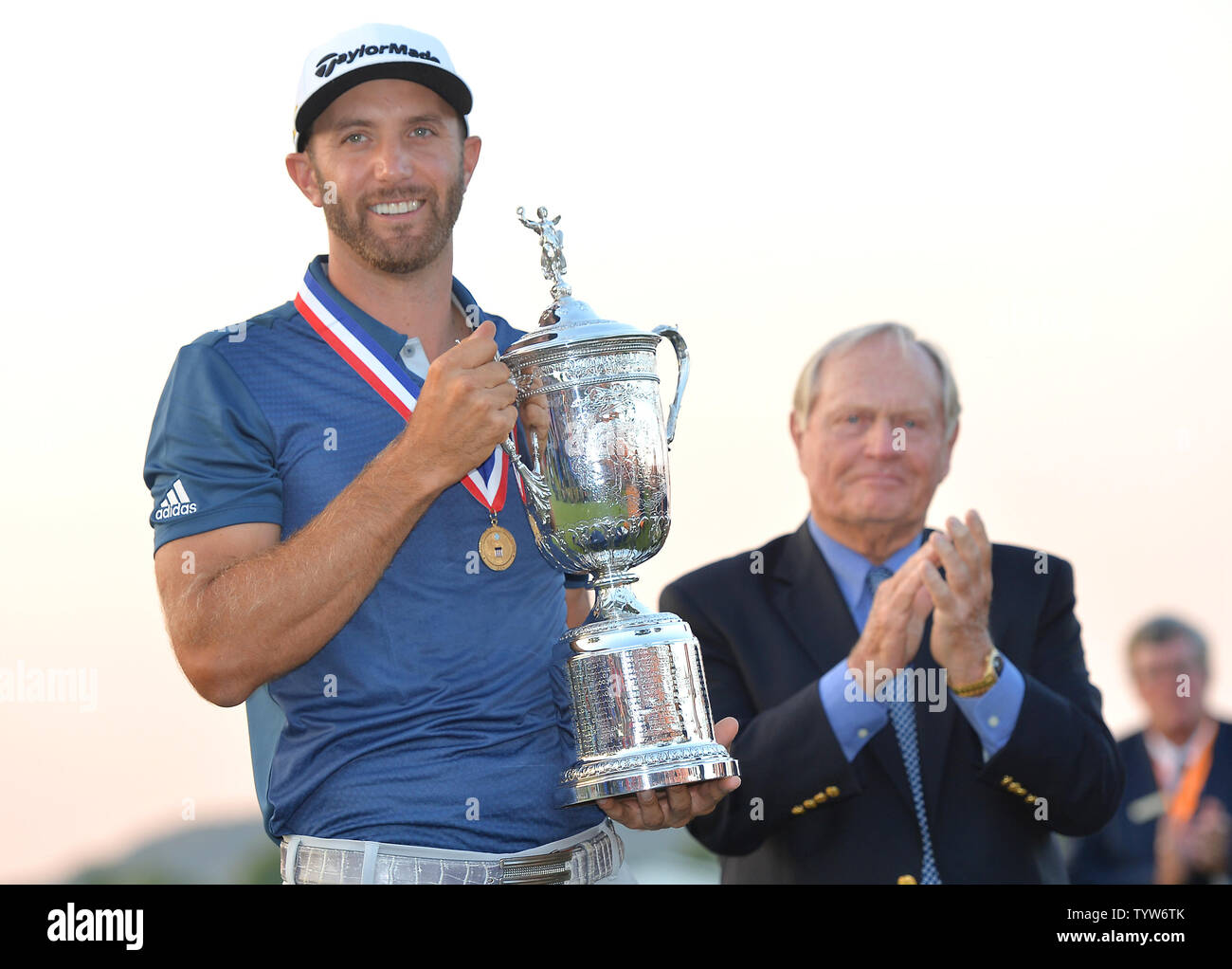La leggenda del Golf Jack Nicklaus applaude come Dustin Johnson detiene il Campionato trofeo su xviii verde dopo aver vinto il suo primo campionato importante nel round finale presso l'U.S. Aperto a Oakmont Country Club vicino Pittsburgh, Pensilvania il 19 giugno 2016. Johnson ha vinto con un punteggio di 5 sotto il par. Foto di Kevin Dietsch/UPI Foto Stock