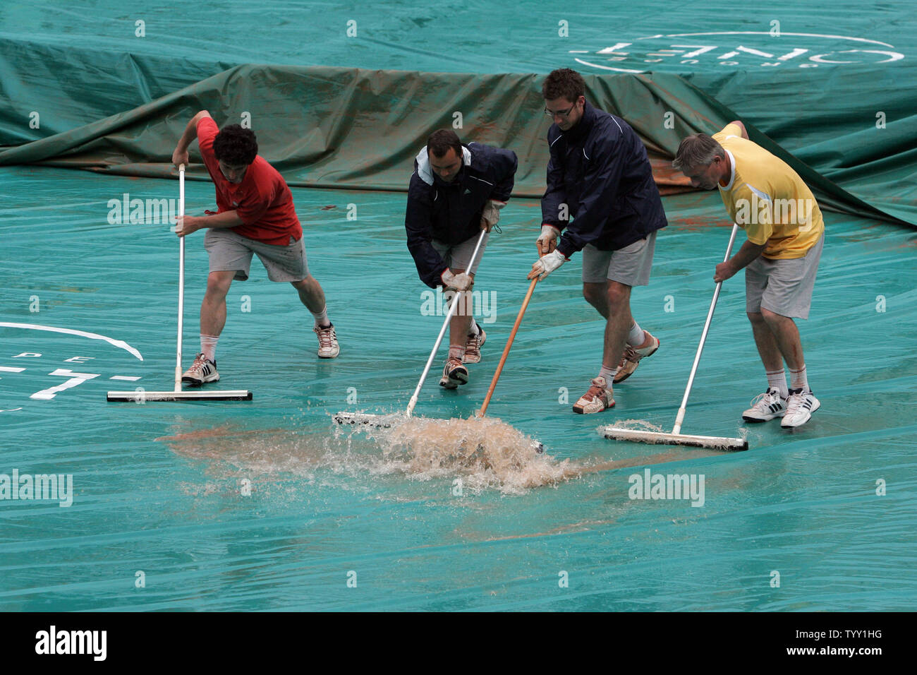 Lavoratori acqua chiara fuori del campo da tennis pioggia coperchi di protezione come ha continuato gli acquazzoni interrotto le partite del terzo giorno di Open di Francia di tennis del torneo al Roland Garros di Parigi, 27 maggio 2008. (UPI foto/Eco Clemente) Foto Stock