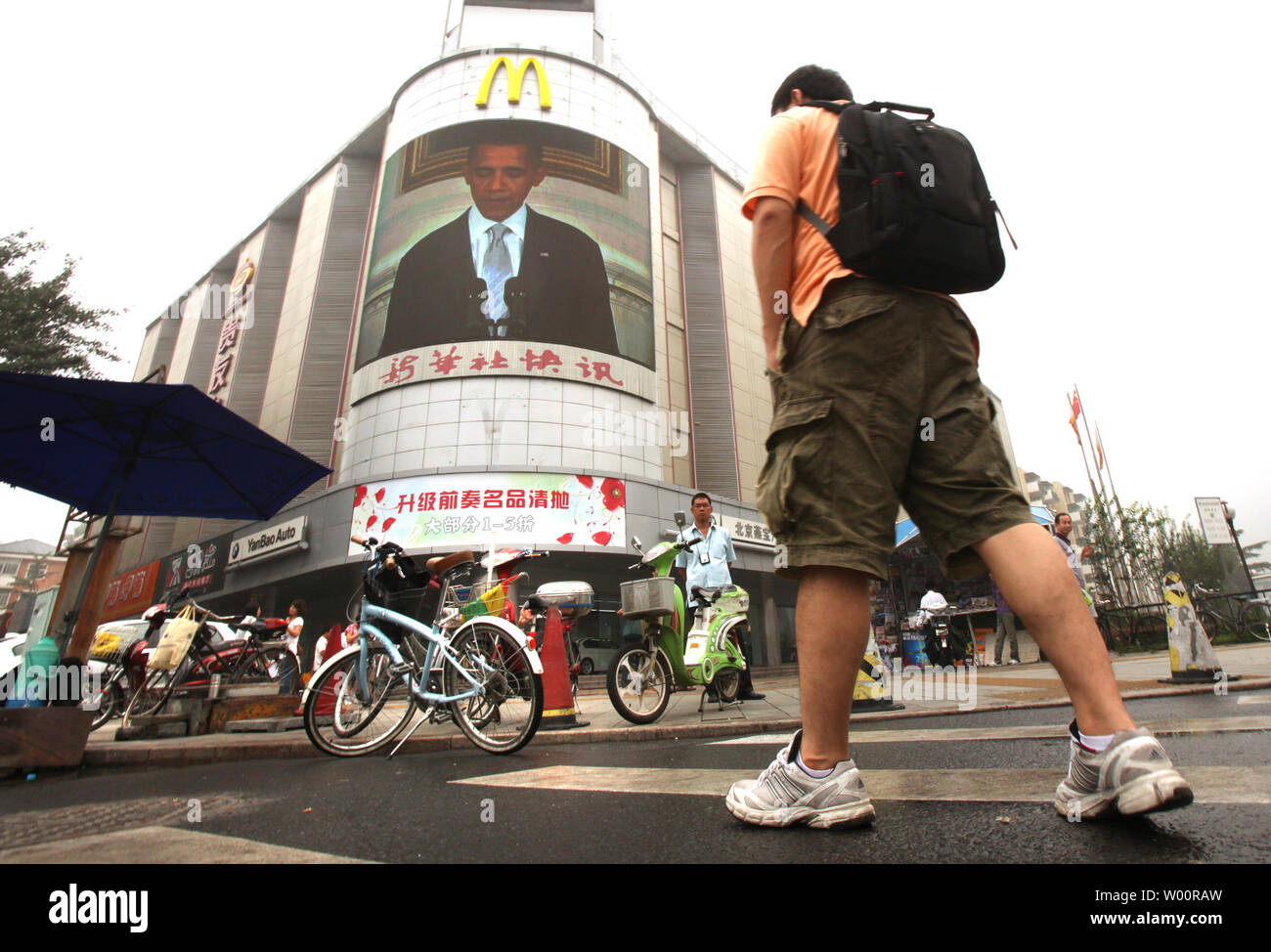 Cinese passato a piedi un centro commerciale che mostra world news, dotato di una storia negli Stati Uniti. Il presidente Barack Obama, nel centro cittadino di Pechino sulla luglio 15, 2010. Il presidente cinese Hu Jintao il mese scorso ha ribadito l importanza dello sviluppo di Cina-USA relazioni, dicendo che legami più stretti contribuisce alla pace, alla stabilità e alla prosperità nella regione Asia Pacifico e il mondo. UPI/Stephen rasoio Foto Stock