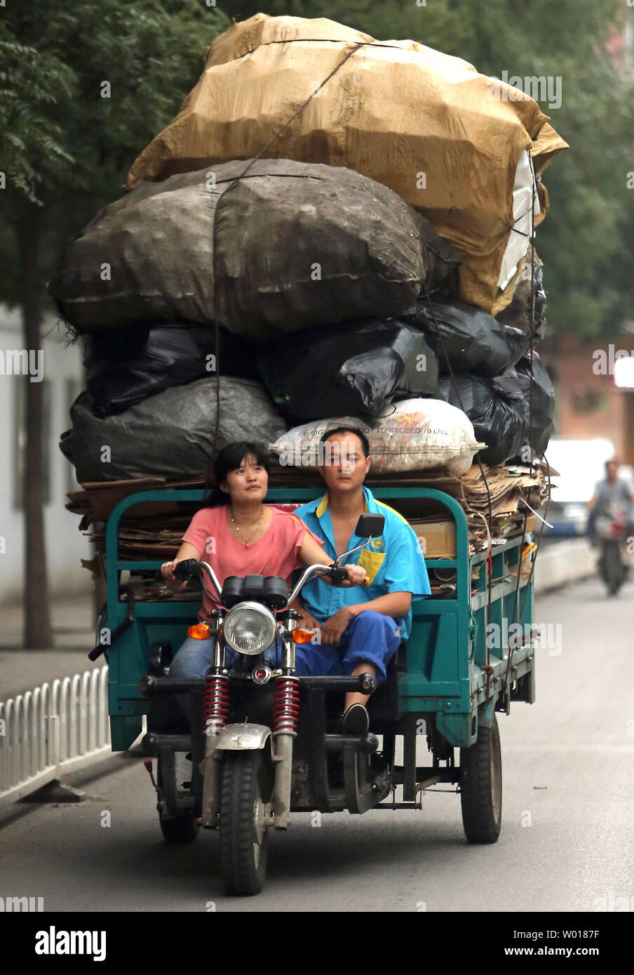 Un giovane cinese cale le giornate di raccolta di rifiuti riciclabili per un drop-off magazzino solo al di fuori di Pechino sulla luglio 22, 2015. Un alto ufficiale cinese ha avvertito che il paese di problemi ambientali derivanti da decenni di sviluppo iper ora minacciano la sua performance economica. Foto di Stefano rasoio/UPI Foto Stock