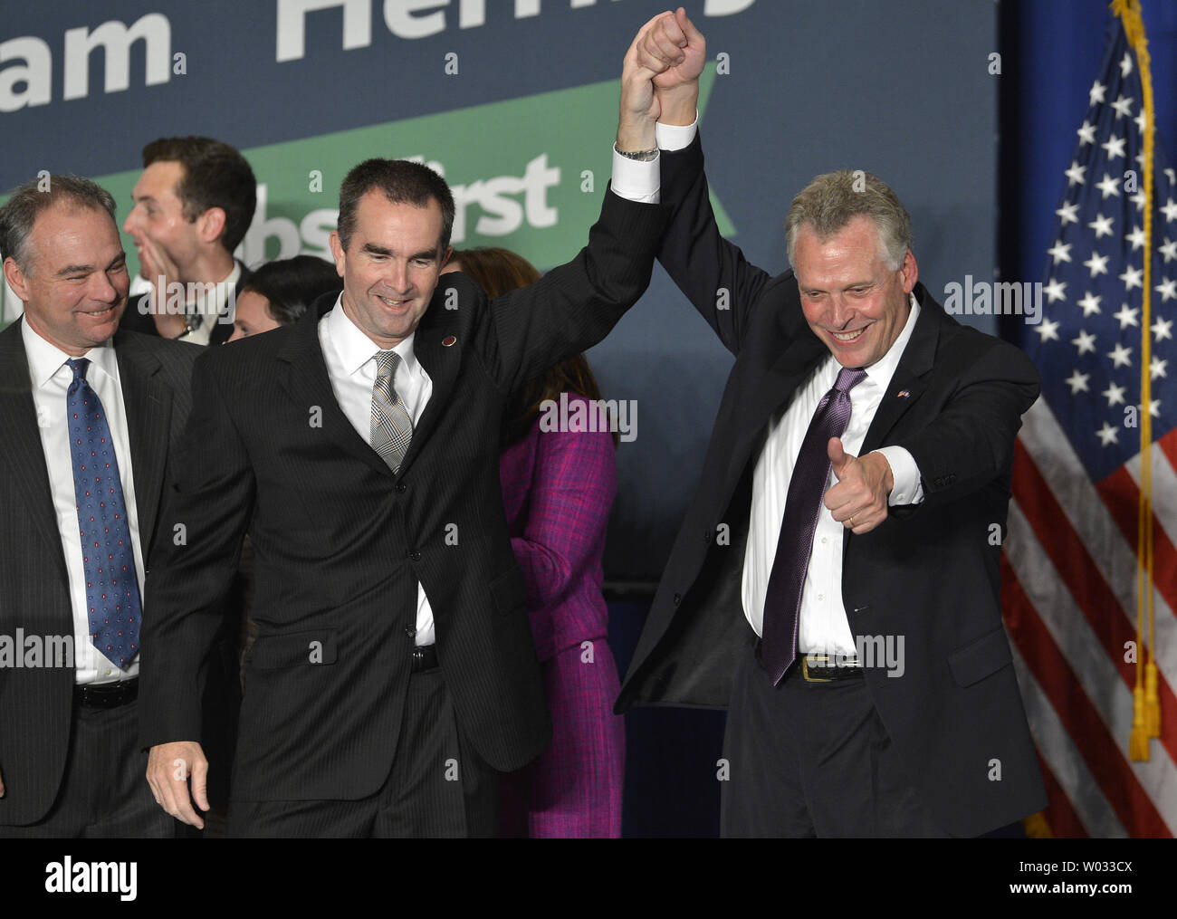 Democratici Terry McAuliffe (R) dà un pollice su come egli si unisce le mani con il suo nuovo Lt. Gov. Ralph Northam come egli sostiene la vittoria in Virginia gubernatorial race come Sen. Tim Kaine (D-VA), (L), orologi, durante una celebrazione in Tyson's Corner, Virginia, 5 novembre 2013. McAuliffe ha sconfitto la Virginia Attorney General il repubblicano Ken Cuccinelli in una gara strettamente sorvegliati dal resto del paese. UPI/Mike Theiler Foto Stock