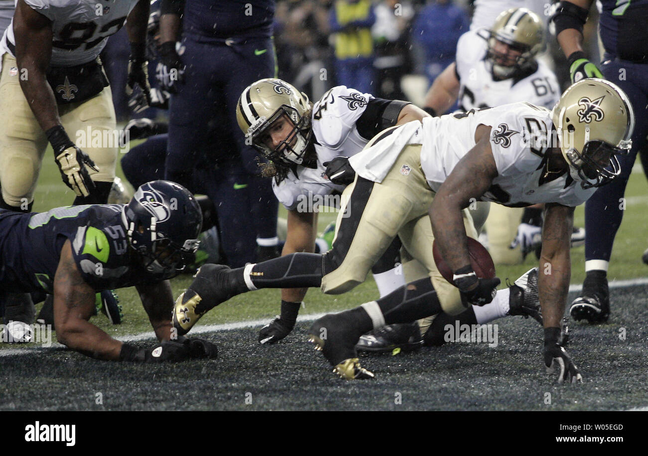 New Orleans Saints running back Khiry Robinsn (29) punteggi un touchdown contro i Seattle Seahawks durante la NFL divisione occidentale dei playoff partita al campo Centurylink a Seattle, Washington il 11 gennaio 2014. Il Seahawks knock off i santi 23-15 al paranco NFC partita di campionato. UPI /Jim Bryant Foto Stock