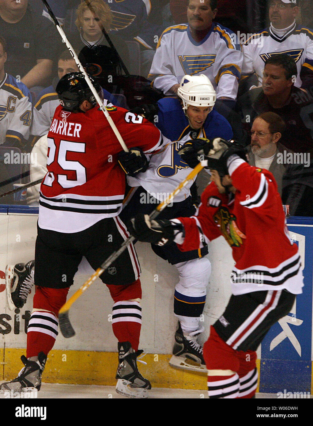 Chicago Blackhawks Cameron Barker (25) e Robert Lang (R) forza San Louis Blues Ryan Johnson nei pannelli durante il primo periodo alla Scottrade Center di San Louis il 19 febbraio 2008. Louis ha vinto il gioco 5-1. (UPI foto/Bill Greenblatt) Foto Stock