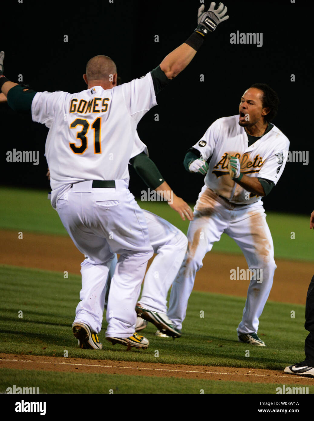 Oakland A's Johnny Gomes (31) corre ad un urla Coco Crisp (R) dopo Crisp individuato nel vincente nel fondo del 9 gioco quattro del campionato americano serie divisionale contro la Detroit Tigers a Oakland Coliseum di Oakland, la California il 10 ottobre 2012. La A ha segnato tre volte in 9 per battere Detroit 4-3. UPI/Terry Schmitt Foto Stock