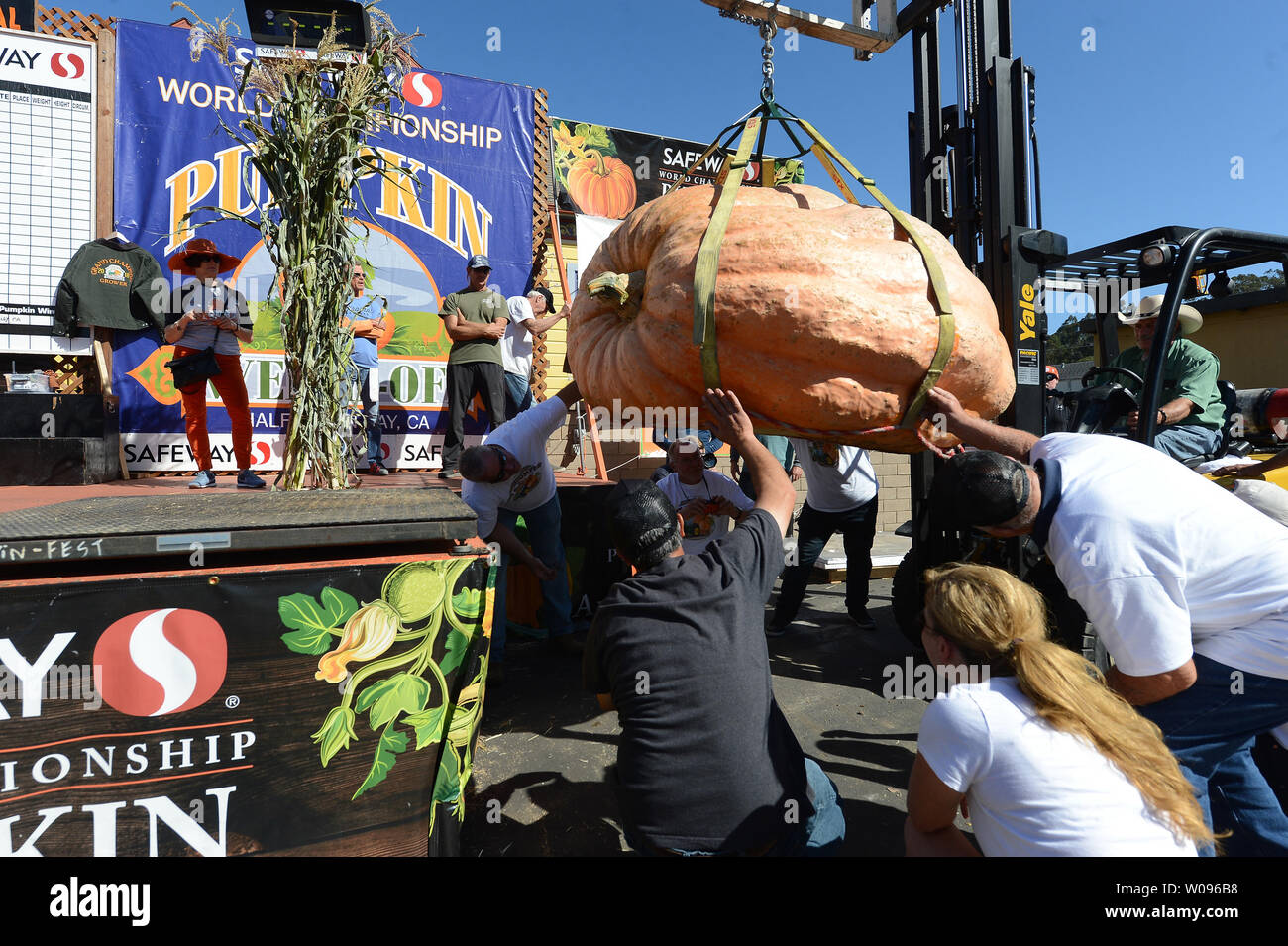 Funzionari ispezionare la parte inferiore di una zucca per essere pesato presso il quarantacinquesimo annuale di Half Moon Bay Weigh-Off Zucca in Half Moon Bay, la California il 8 ottobre 2018. Un 2,170 pound behemoth cresciuto da Steve Daletas di Pleasant Hill, Oregon ha vinto il concorso. Foto di Terry Schmitt/UPI Foto Stock