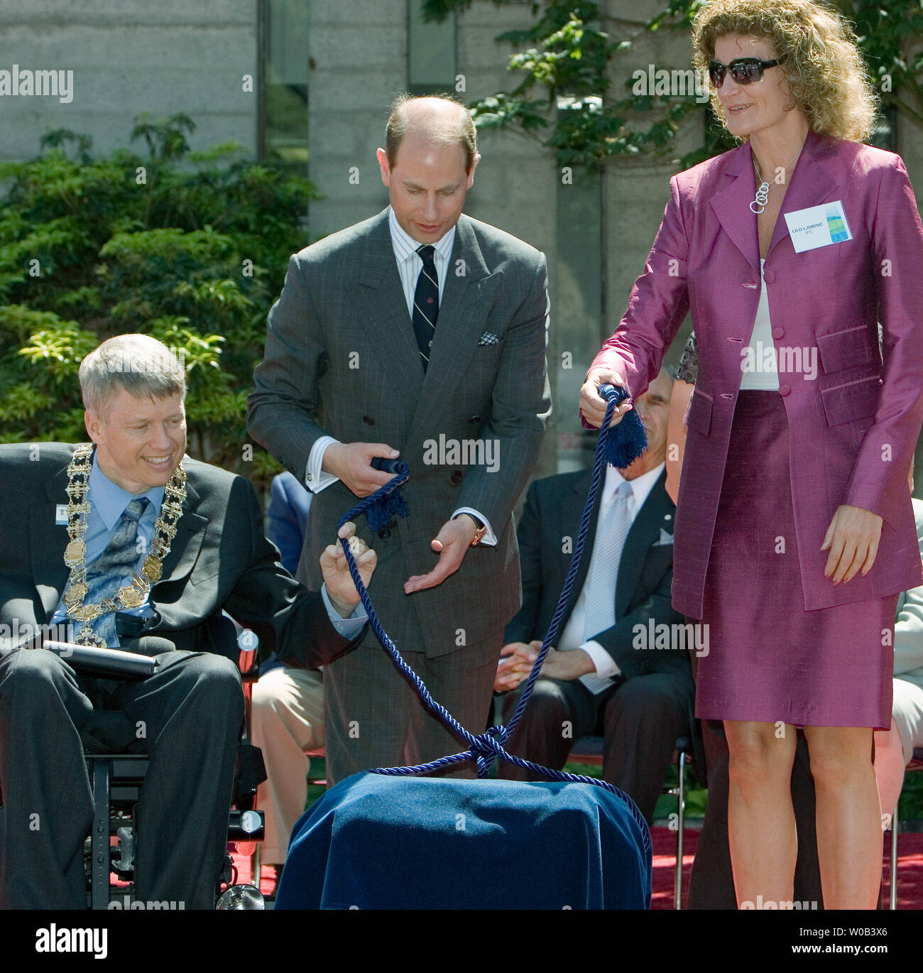 Il sindaco di Vancouver Sam Sullivan (L), Prince Edward, Earl del Wessex e Comitato Paralimpico Internazionale (IPC) stati Lilo Ljubisic (R) scartocci la 2010 Bandiera Paralimpica per sollevamento a City Hall in Vancouver, British Columbia, Giugno 7, 2006. (UPI foto/Heinz Ruckemann) Foto Stock