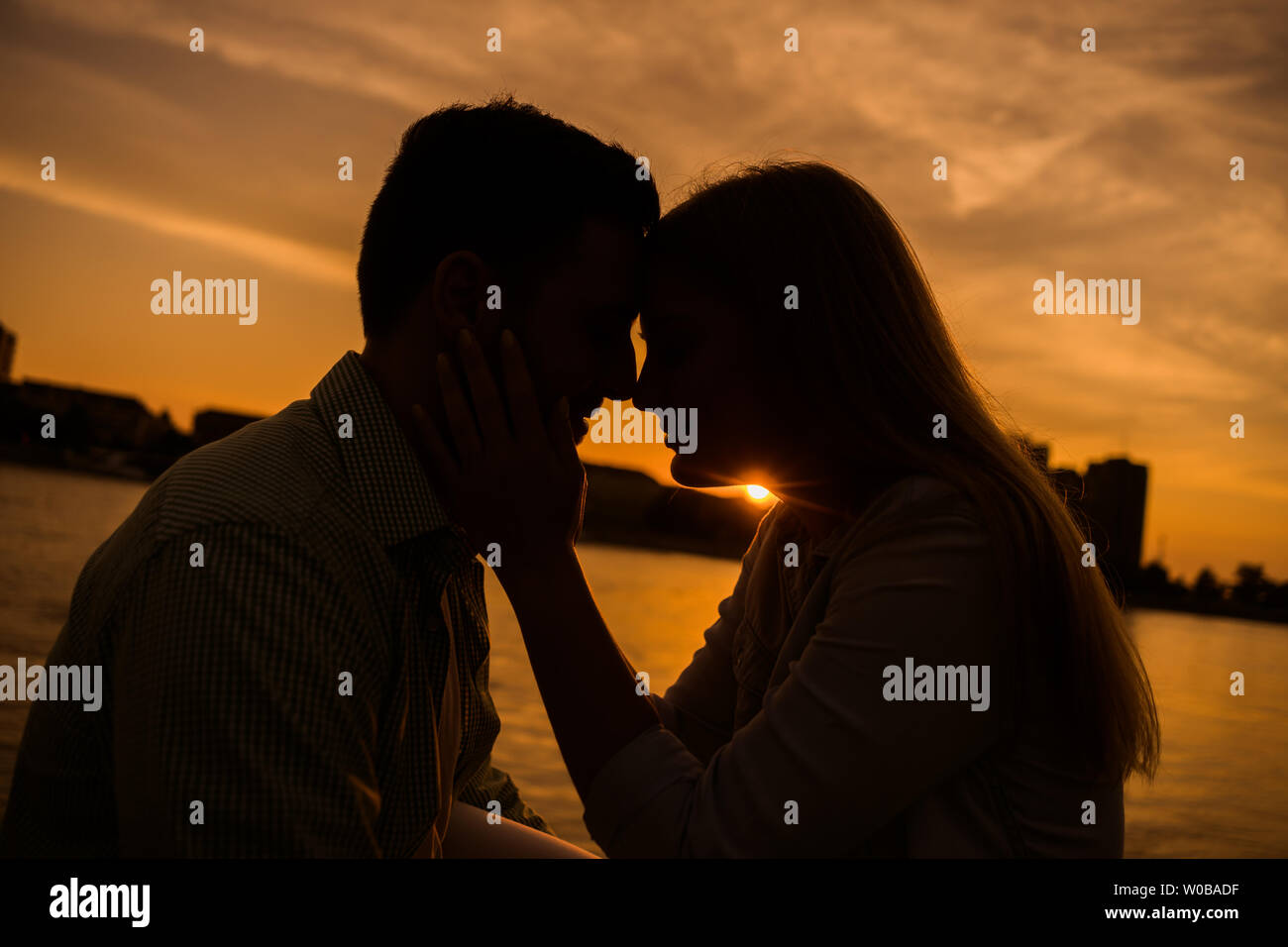 Coppia felice in amore è godersi il tramonto in città. Foto Stock