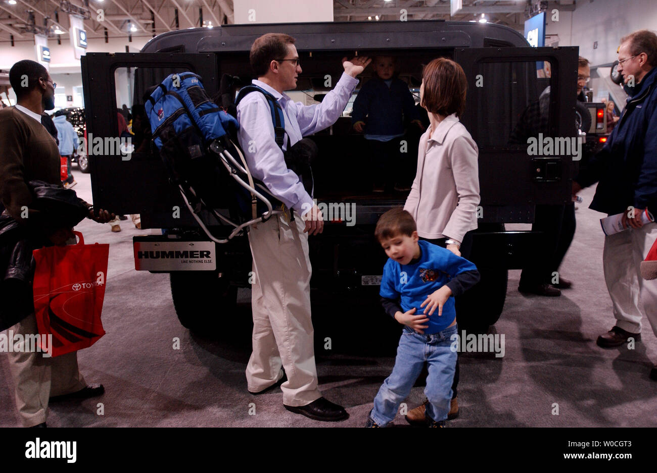 Una famiglia che ha scelto di non essere identificati al 2005 Washington Auto Show prendere uno sguardo più da vicino a un nuovo Hummer sul display al Washington Convention Center il 27 dicembre 2004. Il salone sarà aperto fino al 2 gennaio e presenterà le concept car e nuovi rilasci di quasi tutte le auto commerciali makers. (UPI foto/Michael Kleinfeld) Foto Stock