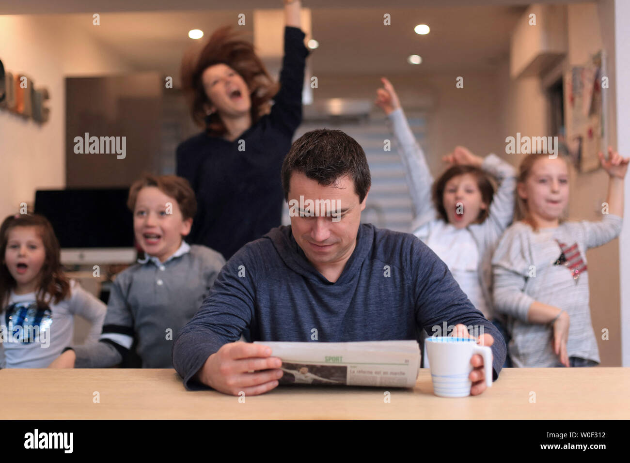 La famiglia grande, l'uomo la lettura di notizie Foto Stock