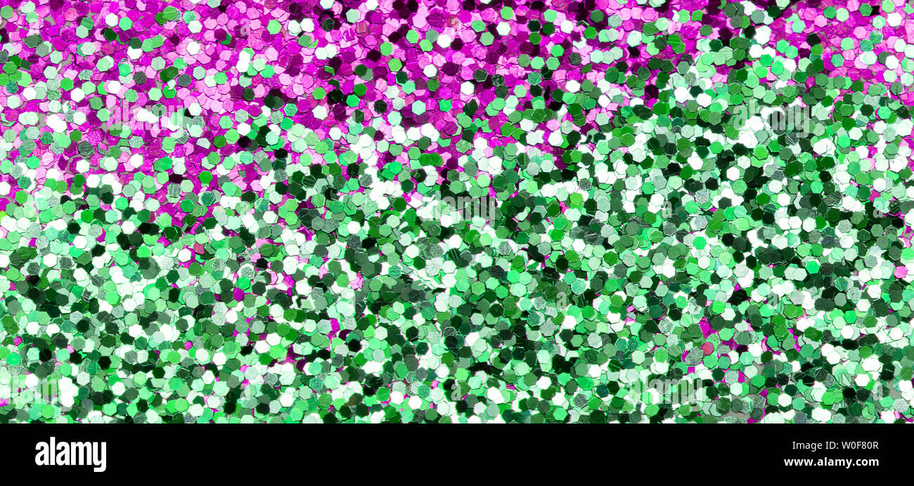 Lucido con sfondo verde e rosa glitter close up Foto Stock