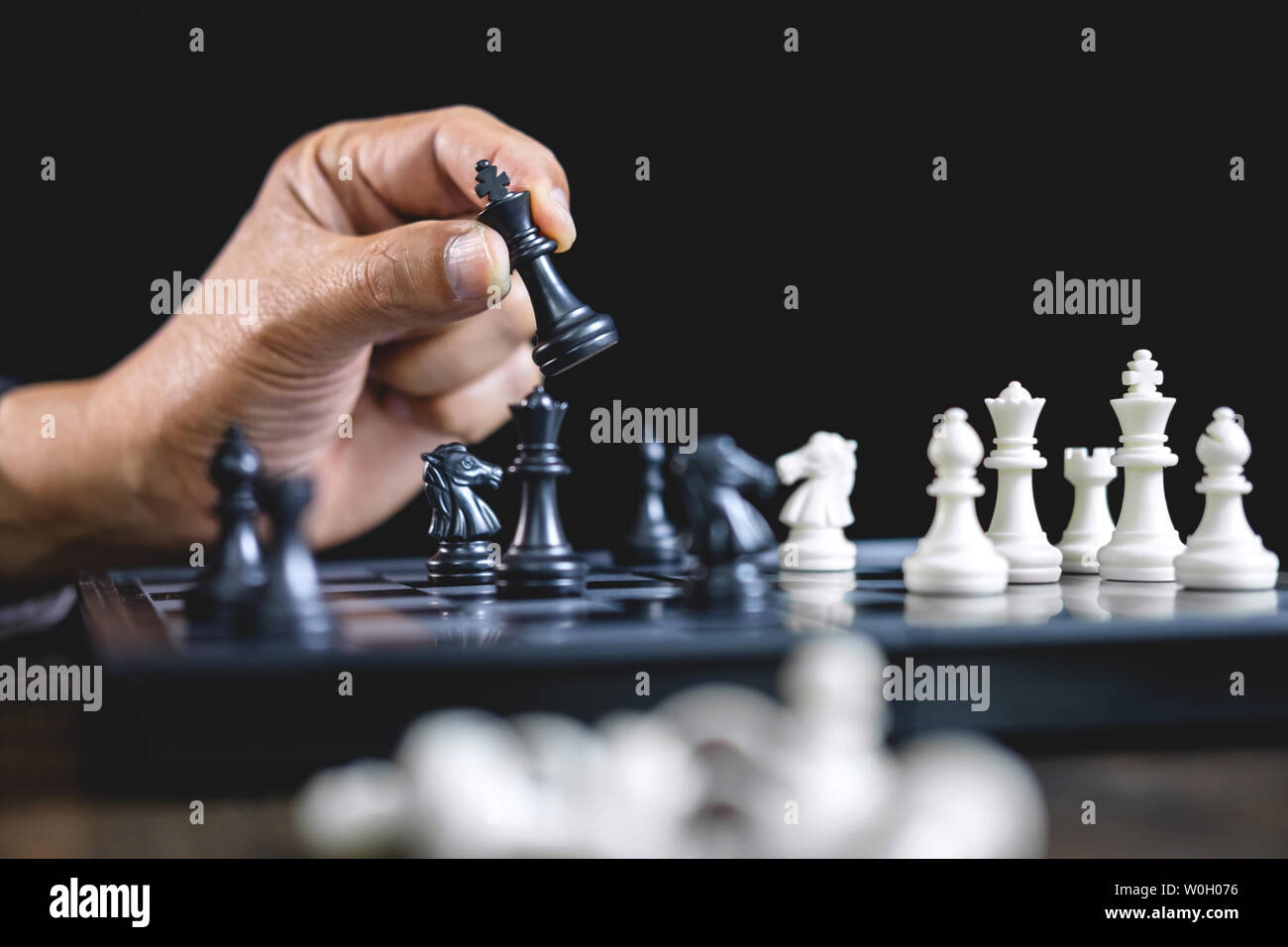 Imprenditore giocando a scacchi e strategia di pensiero circa il crash di rovesciare la squadra opposta e analisi di sviluppo per vincere e di successo. Foto Stock