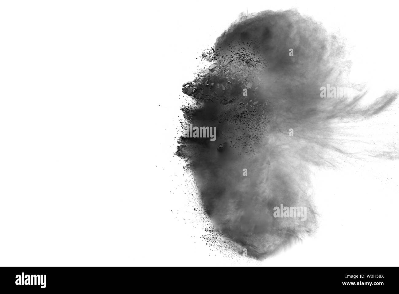 Polvere nera in esplosione contro uno sfondo bianco. Nero le particelle di polvere di schizzi. Foto Stock