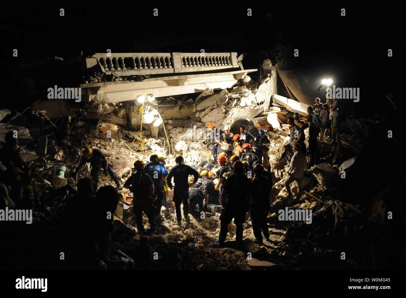 Membri del Los Angeles County Fire Department di ricerca e salvataggio della squadra per eliminare detriti in corrispondenza di un edificio crollato nel centro di Port-au-Prince, Haiti, il 17 gennaio, 2010. Parte-au-Prince è stato colpito da un devastante terremoto di magnitudine 7.0 a gennaio 12, 2010. UPI/Justin Stumberg/US Navy Foto Stock