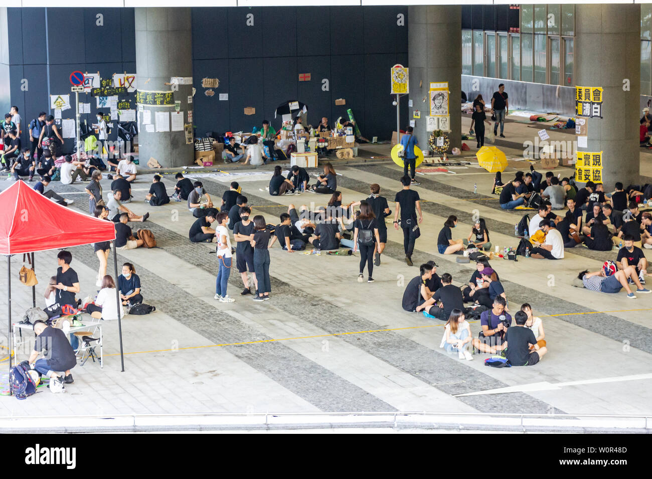 Hong Kong 2019 extradition bill protestare : manifestanti indossare nero e rilassatevi con gli amici al campo base nella parte anteriore del Governo di HK HQ Foto Stock