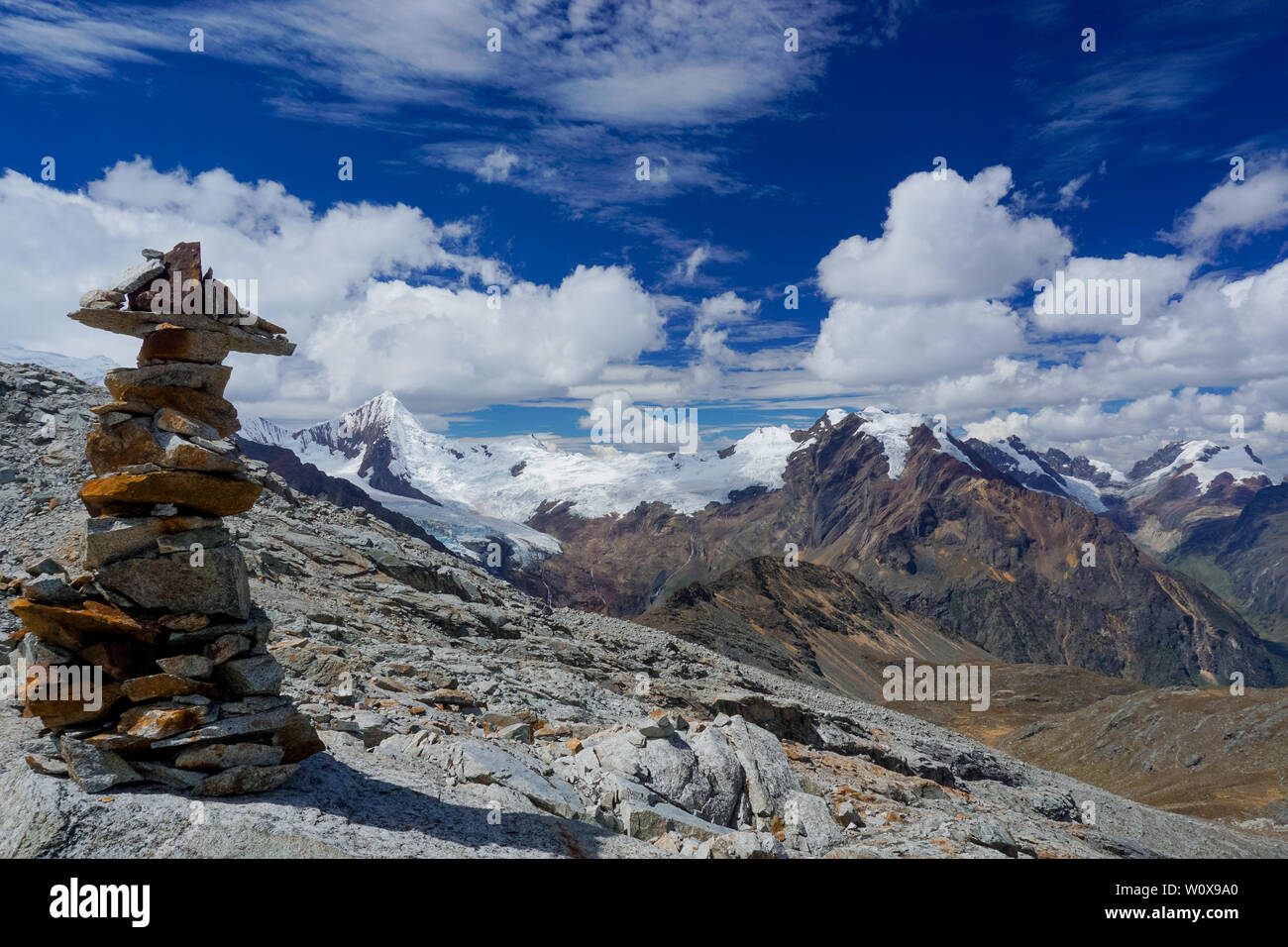 Il pittoresco paesaggio di montagna nella Cordillera Blanca nelle Ande del Perù con una pietra cairn in primo piano Foto Stock