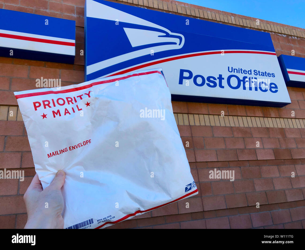 SCOTTSDALE, AZ / STATI UNITI D'America - 23 Febbraio 2019: far cadere un Servizio Postale degli Stati Uniti (USPS) Posta Prioritaria confezione per la spedizione presso l'ufficio postale. Foto Stock