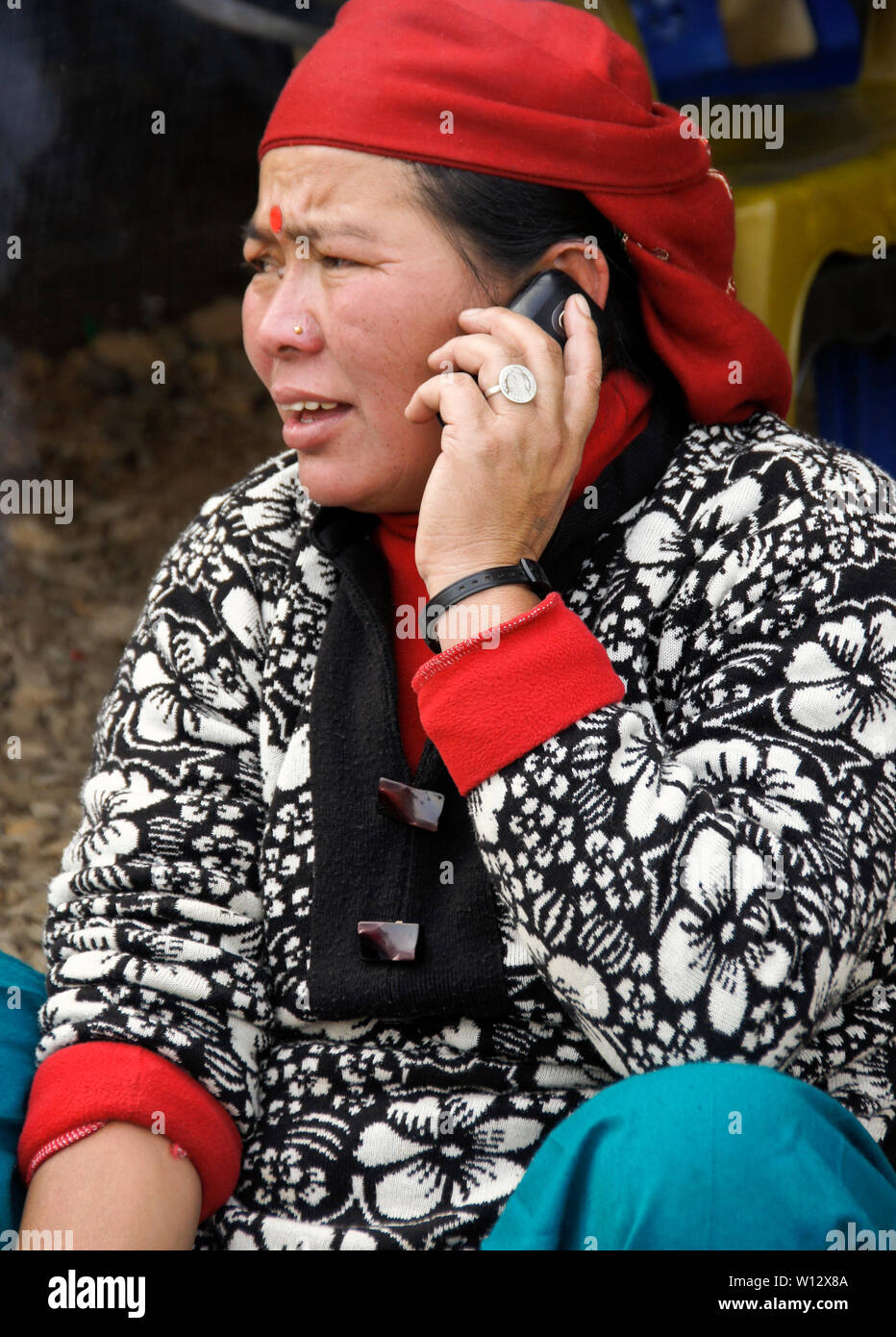 Donna in abito tradizionale parlando al telefono cellulare in Nepal Foto Stock