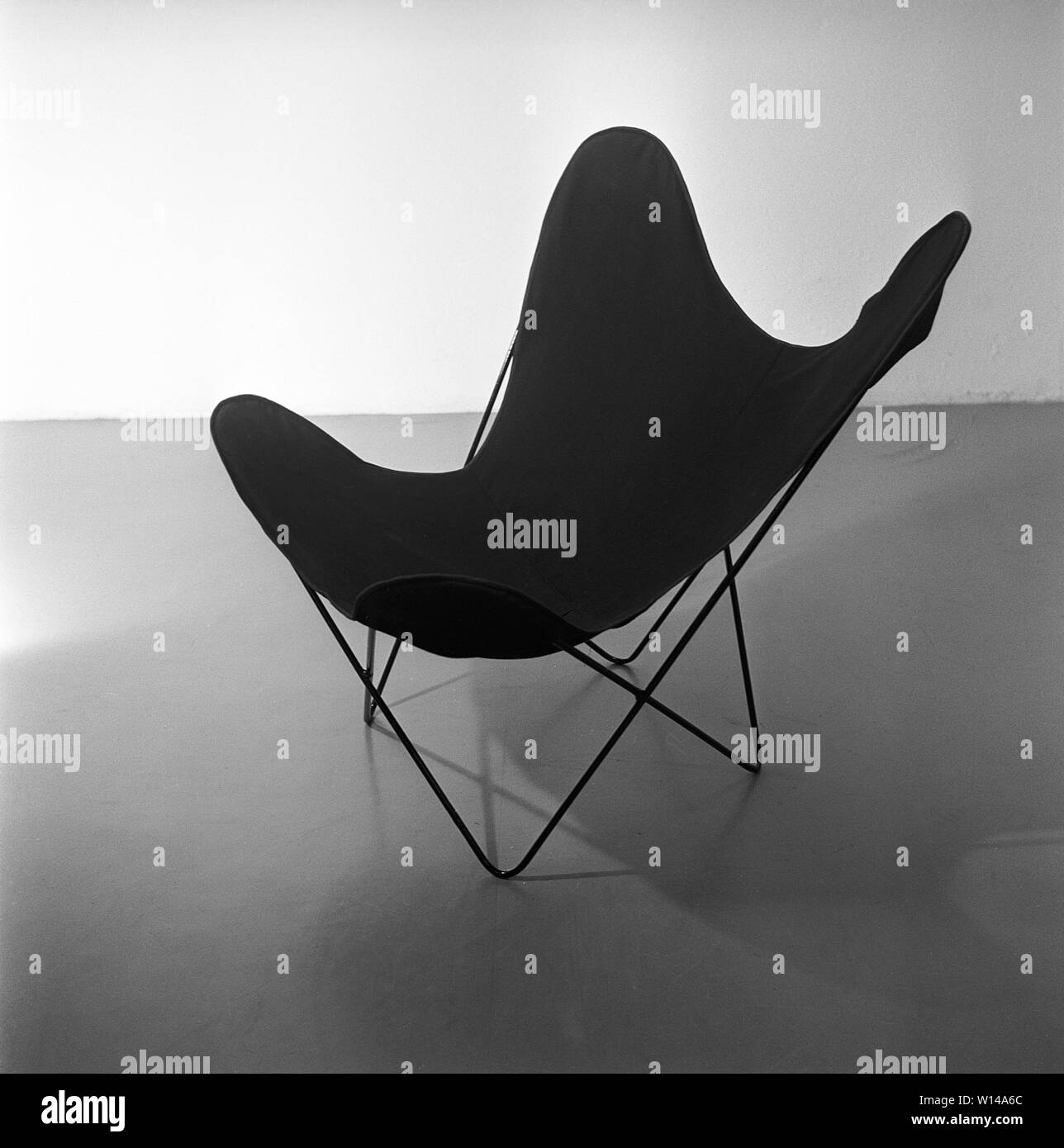 Home decor degli anni cinquanta. La Butterfly sedia, noto anche come BKF sedia o poltrona Hardoy. La sedia ha il suo soprannome a causa del design. Per molte persone la Cattedra è il simbolo della ribellione giovanile contro una generazione di genitori che volevano che i loro figli a sedere eretti. La sedia è stata creata da due architetti argentino Juan Kurchan e Jorge Ferrari Hardoy e spagnolo Antonio Bonet nel 1930s. Esso è stato chiamato BKD ma è stato ritenuto difficile da vendere, probabilmente a causa del suo design futuristico. American Hans Knoll re lo ha introdotto nel 1947 e divenne un best-seller internazionale mobili. Swed Foto Stock