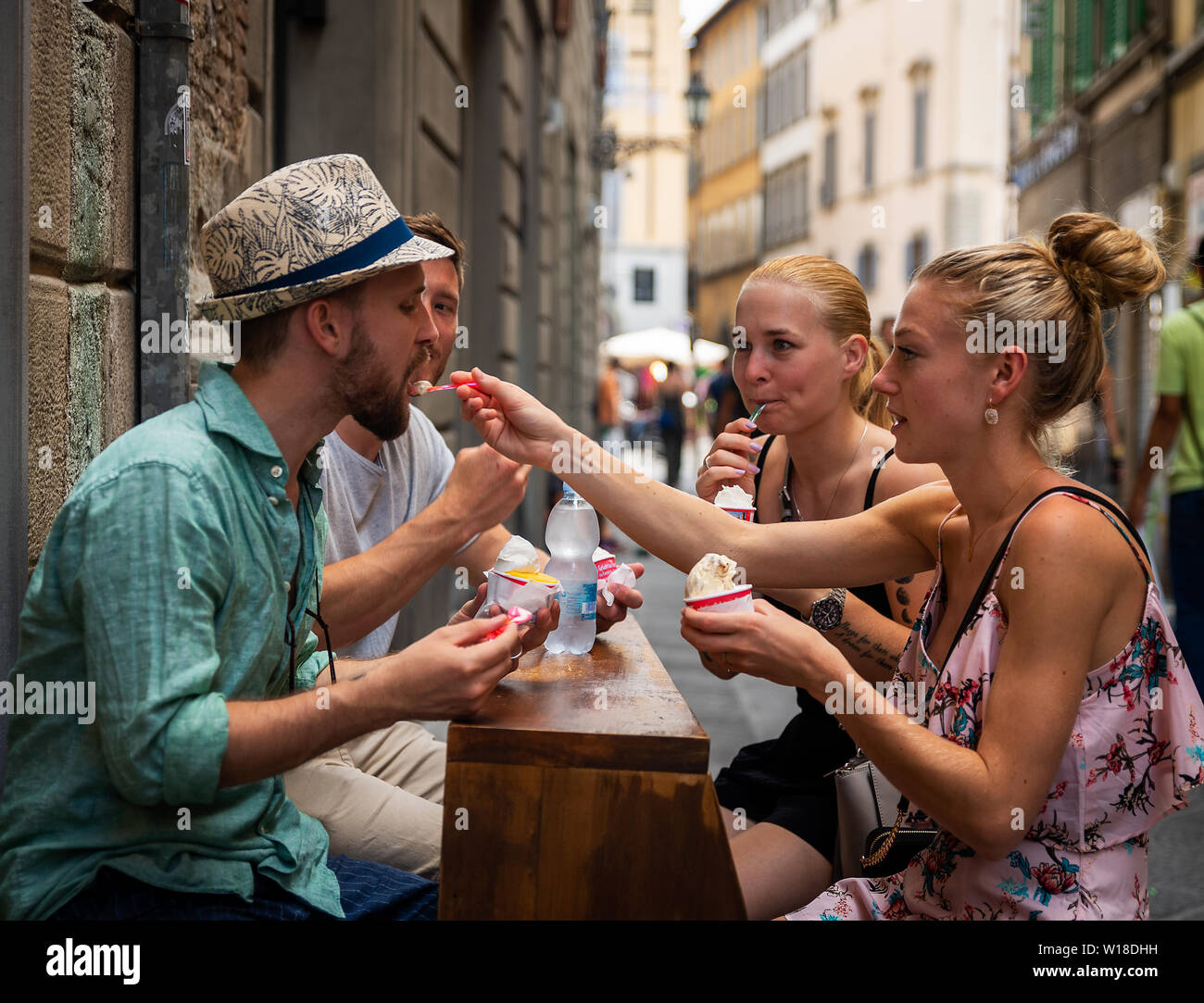 Quattro persone godendo il gusto del gelato italiano nel Florencs Italia Foto Stock
