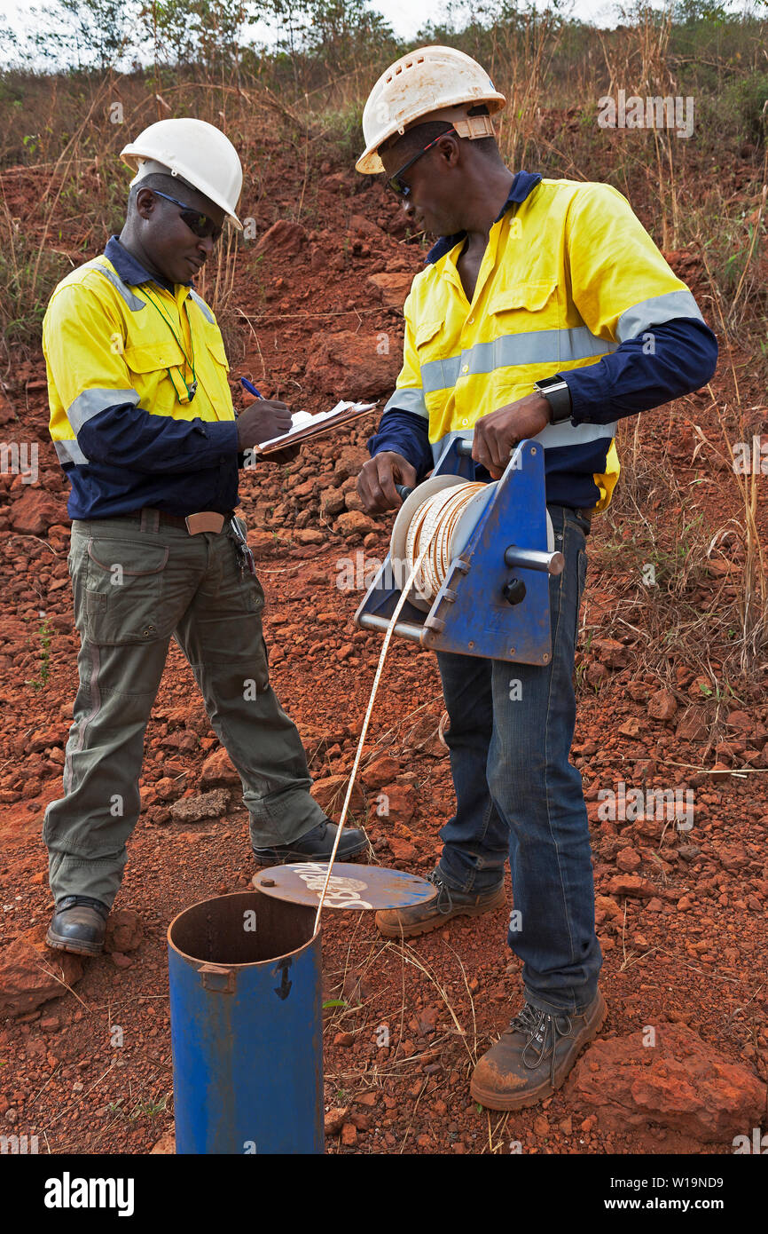 Le operazioni di data mining per il trasporto e la gestione di minerale di ferro. Idro geologi miniera di controllo permanente del livello dell'acqua - la misurazione della profondità del foro di trivellazione in ogni settimana. Foto Stock