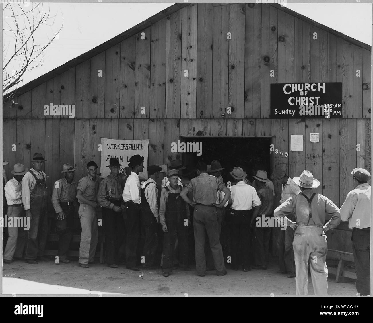 Arvin, Kern County, California. Line up per rilievo di stato il giorno di paga. Mostra l'esterno dell'edificio. Questo b . . .; Portata e contenuto: Full didascalia recita come segue: Arvin, Kern County, California. Line up per rilievo di stato il giorno di paga. Mostra l'esterno dell'edificio. Questo edificio è utilizzato per il lavoratore's alliance riunioni, Chiesa di Cristo i servizi e la sede centrale per la distribuzione dei controlli S.R.A.. Questa è una zona della rapida crescita shacktown europee la maggior parte dei client di sfiato raffigurata qui abitano questi nuovi baraccopoli rurale. Foto Stock