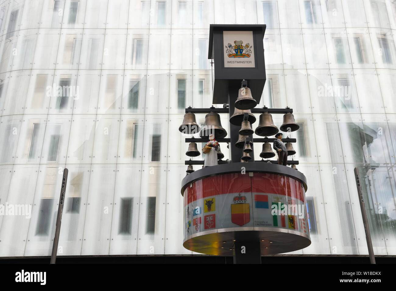 Glockenspiel svizzero al tribunale svizzero Leicester Square con M&M's mondo moderno edificio di vetro in background a Westminster London Inghilterra England Foto Stock