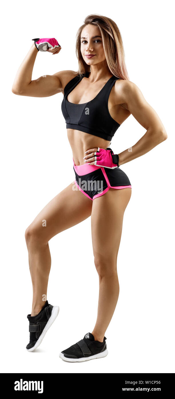 Giovane donna in abbigliamento sportivo di dimostrare il suo bel corpo muscoloso. Isolato su bianco. Foto Stock