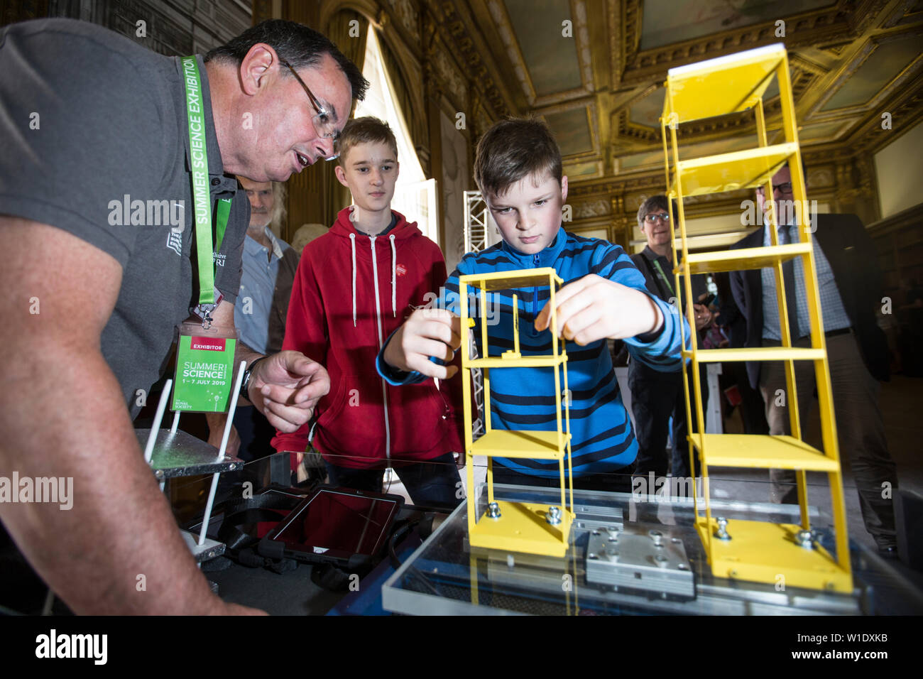 Royal Society Summer Science Exhibition, ragazzi imparare a moderare la frequenza di risonanza degli edifici durante un terremoto tremore, London REGNO UNITO Foto Stock