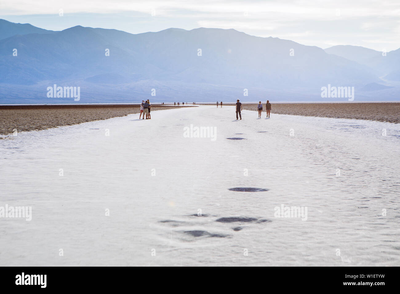 Persone che camminano attraverso il bacino di Badwater, bacino endorheic, Death Valley National Park, Inyo, California, USA Foto Stock