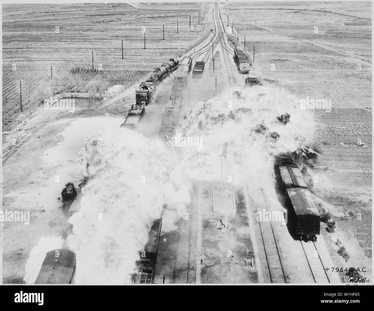 Oltre la Corea del Nord--Bombardiers in B-26s del Quinto Air Force 452 Luce parafango bomba utilizzato la Y in tracce come punto di mira e la precisione dei loro calcoli è attestata da questi due fiori di fiery di napalm, sia direttamente a cavallo di una linea riempito con nemico automobili della ferrovia. Le impostazioni internazionali di questa drammatica foto è un cantiere di smistamento sulla principale linea ferroviaria che porta a sud da Wonsan, importante East coast città portuale. Foto Stock