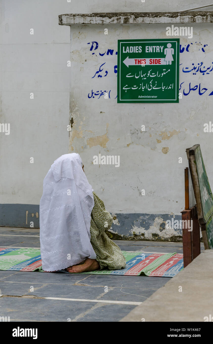 La donna del Kashmir locale che prega al santuario di Hazratbal, Srinagar, Jammu e Kashmir, India Foto Stock