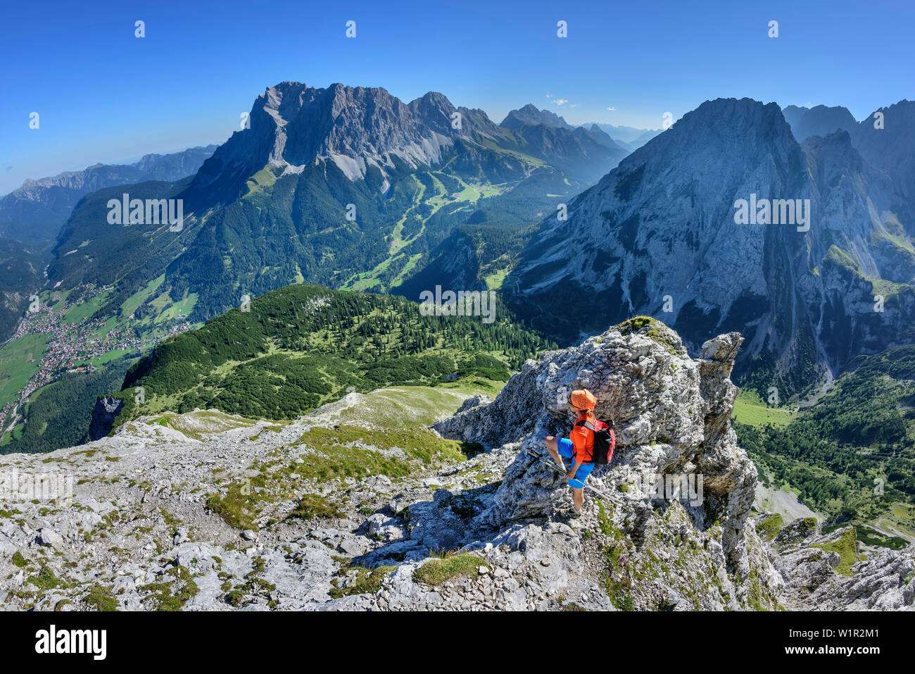 Donna che guarda verso Ehrwald e Wetterstein gamma con Zugspitze, Ehrwalder Sonnenspitze, gamma di Mieming, Tirolo, Austria Foto Stock