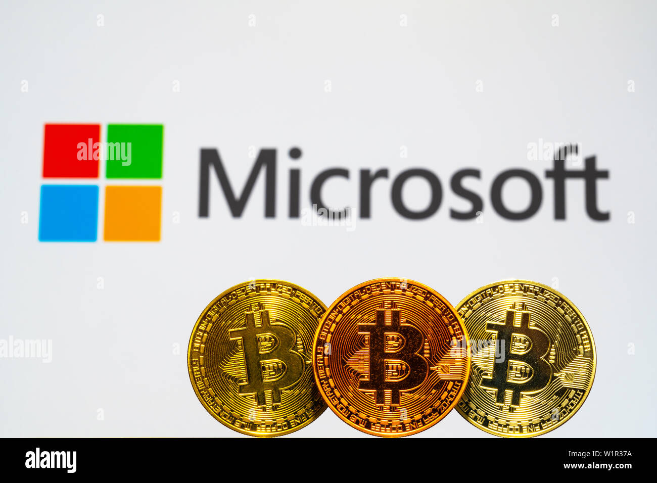 Oro Bitcoin le monete con il logo Microsoft sulla schermata di sfondo. Un nuovo tipo di business finance concept Foto Stock