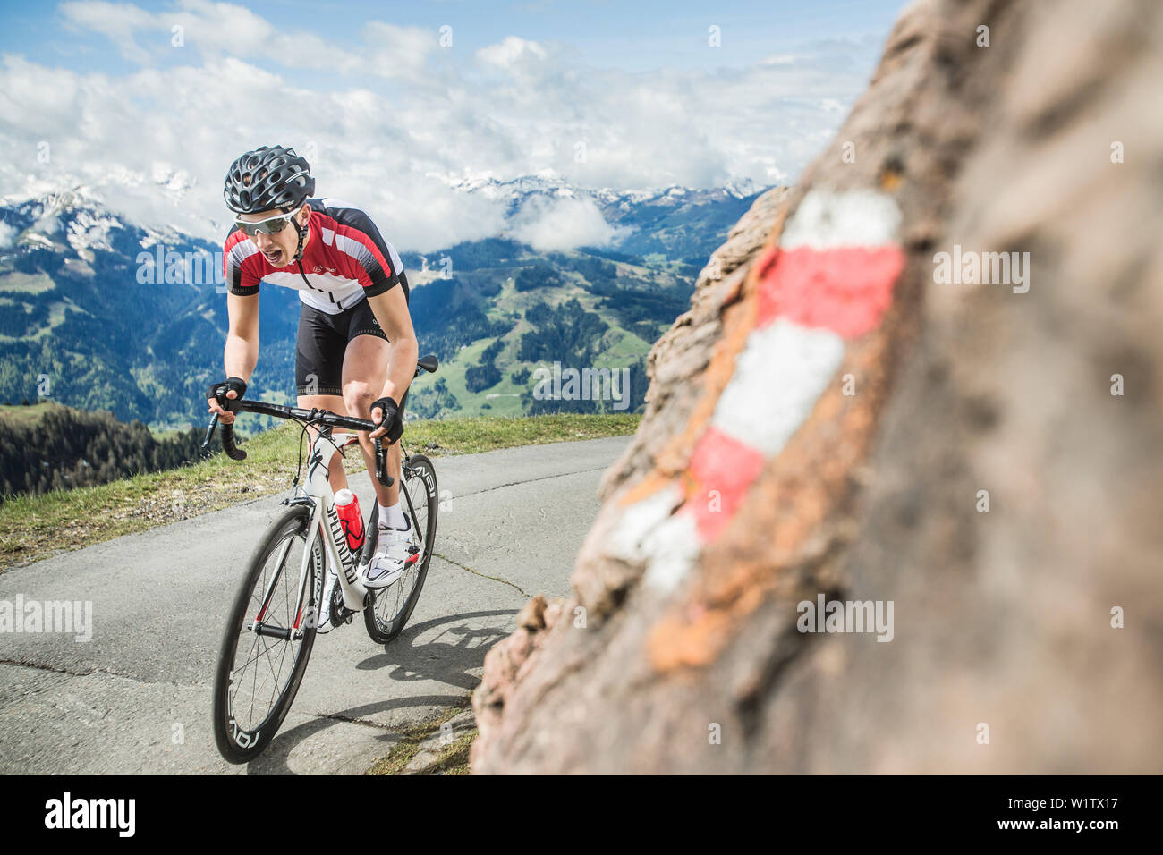 Giovane uomo nel suo ciclo di corse nelle Alpi Kitzbühler, Kitzbühlerhorn, Tirolo, Austria Foto Stock