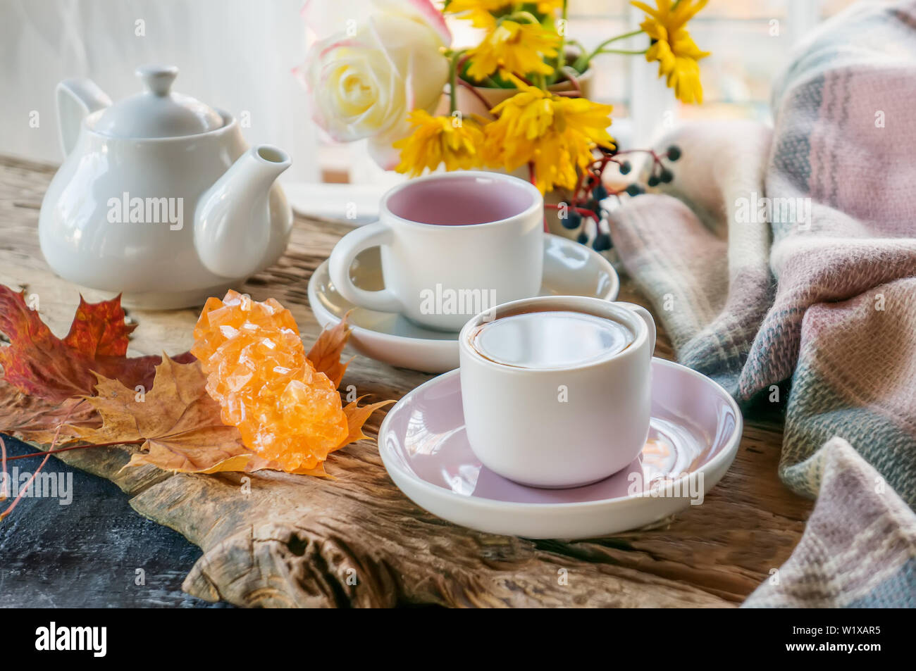 D'autunno bella composizione con tè. Foglie di autunno e coppe con zucchero d'uva su un albero rustico sfondo. il concetto di caduta stagione. soft appare Select Foto Stock