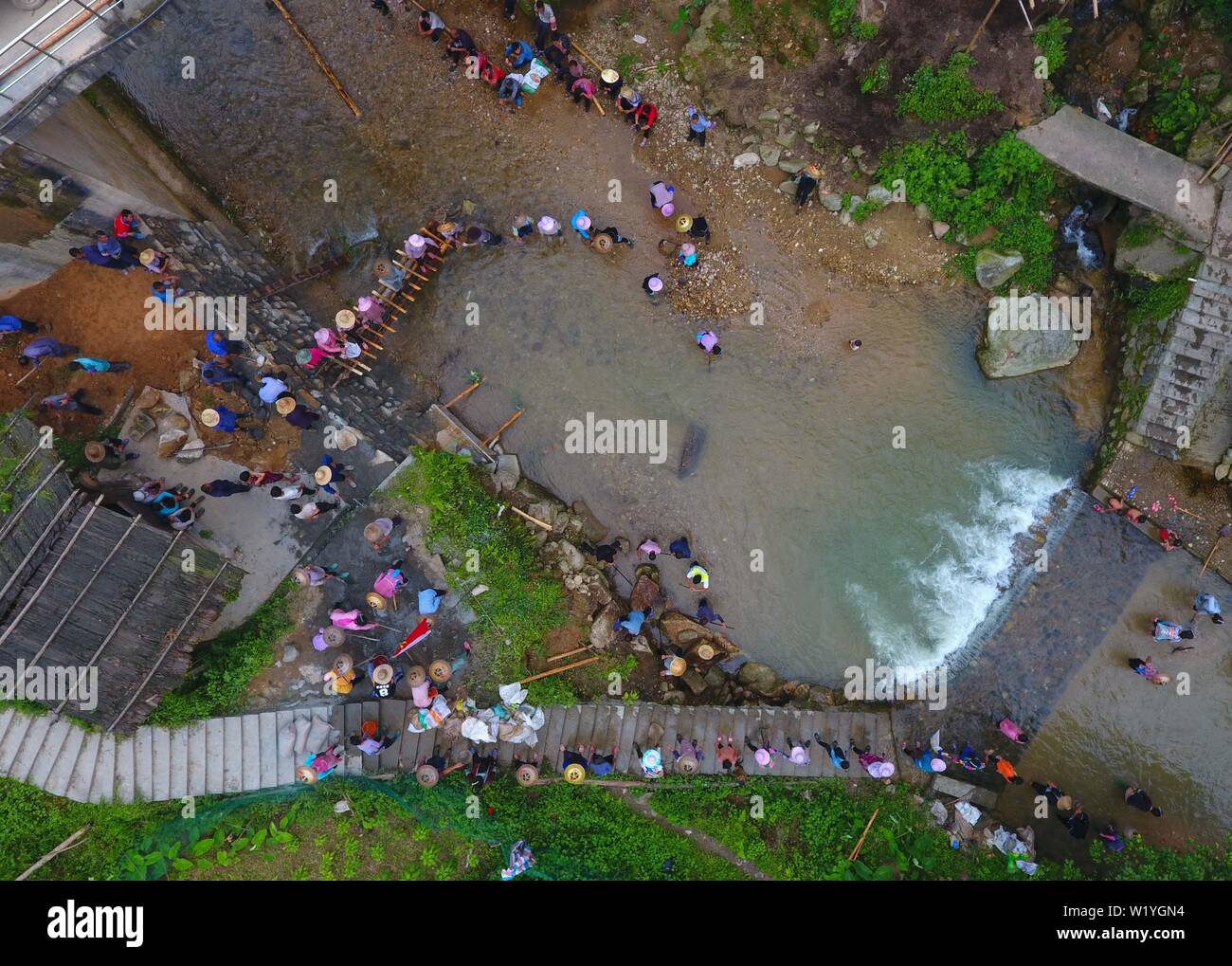 (190704) -- RONGSHUI, 4 luglio 2019 (Xinhua) -- In questa foto aerea adottate il 3 luglio 2019, la lotta contro la povertà i funzionari unire gli abitanti di un villaggio di costruire una diga sul fiume Wuying nel villaggio di Rongshui Miao contea autonoma, Liuzhou, sud della Cina di Guangxi Zhuang Regione autonoma. Poveri di infrastrutture di trasporto in una prevalentemente montuoso terreno ha lasciato Rongshui County ossessionato dalla miseria. Per anni, risolvendo Rongshui di problemi di povertà rimane una priorità per i funzionari incaricati della lotta contro la povertà. In una recente campagna, la festa comunale servizio organizzazione di Liuzhou e la sua Rongshui su Foto Stock