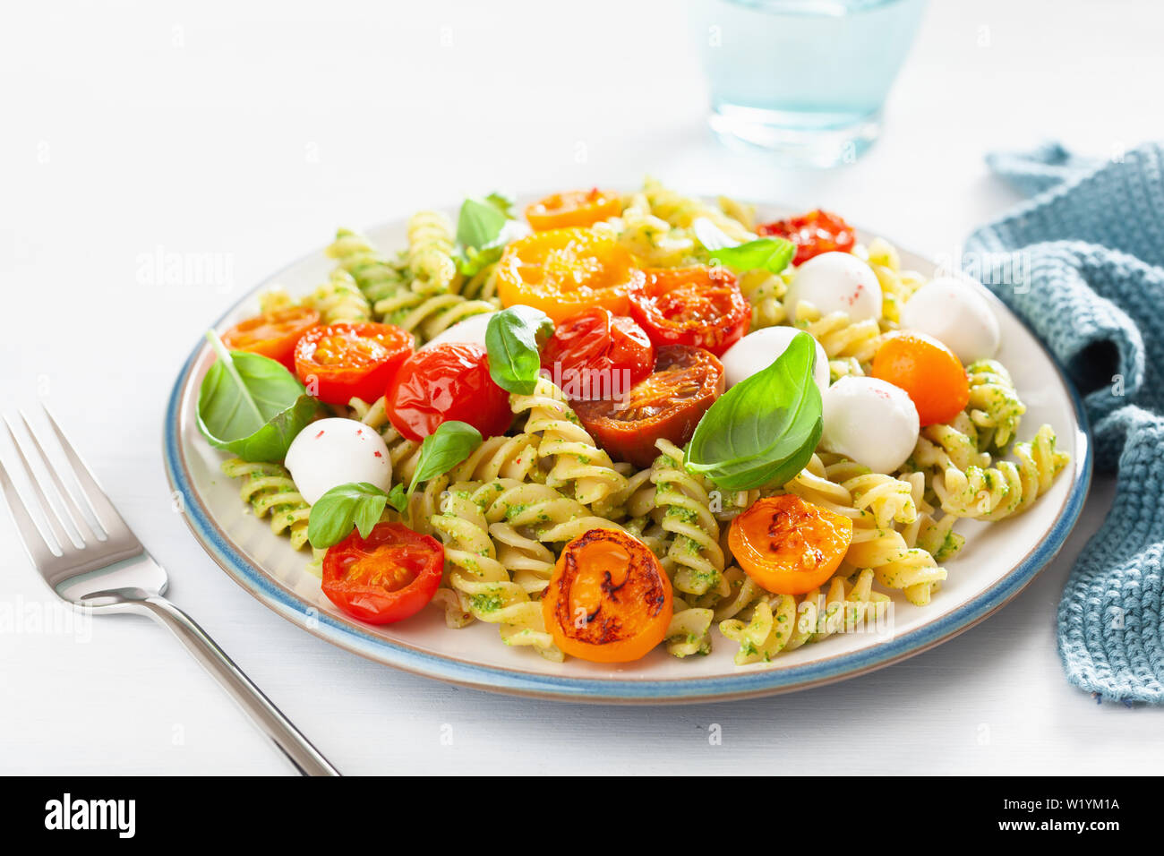 Una sana fusilli al pesto, arrosti di pomodori, mozzarella Foto Stock