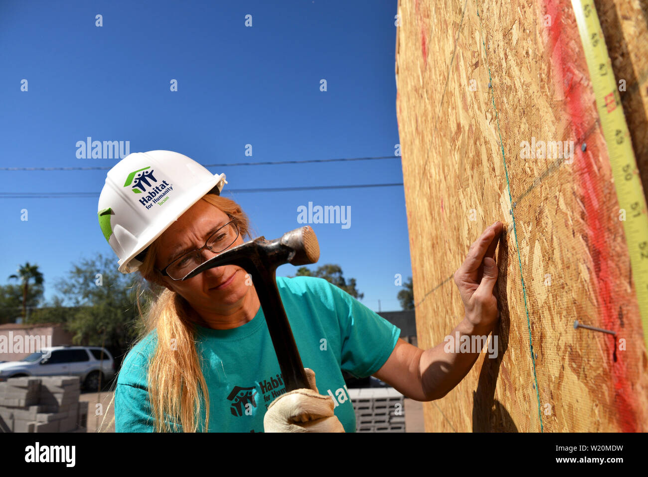 Un potenziale proprietario lavora al Amphi sito in costruzione per l'Habitat per l'umanità, Tucson, Arizona, Stati Uniti. Foto Stock