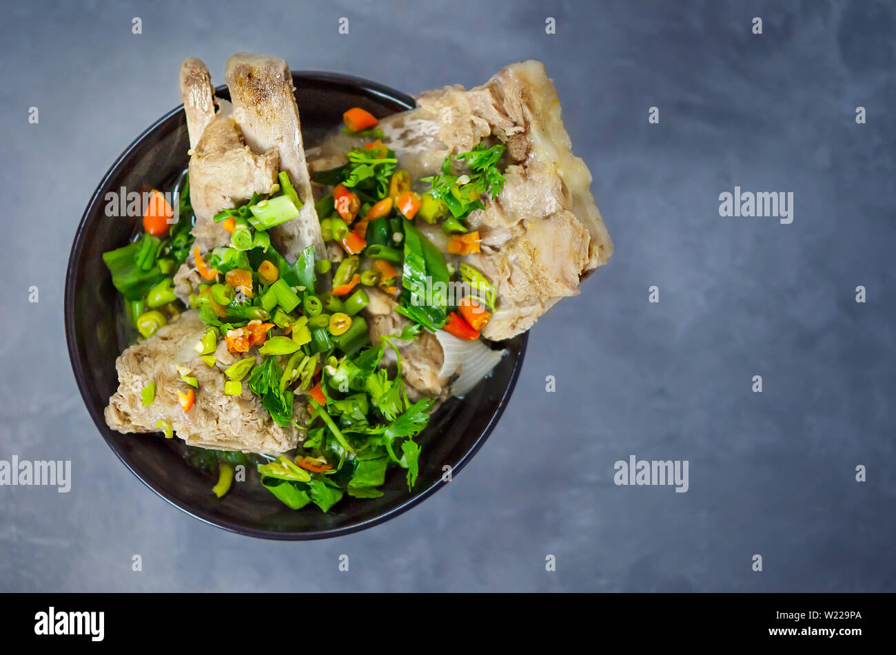 Osso di maiale con peperoncino e Verdure piccanti e minestra acida nella ciotola nero , ( Leng minestra ) Foto Stock
