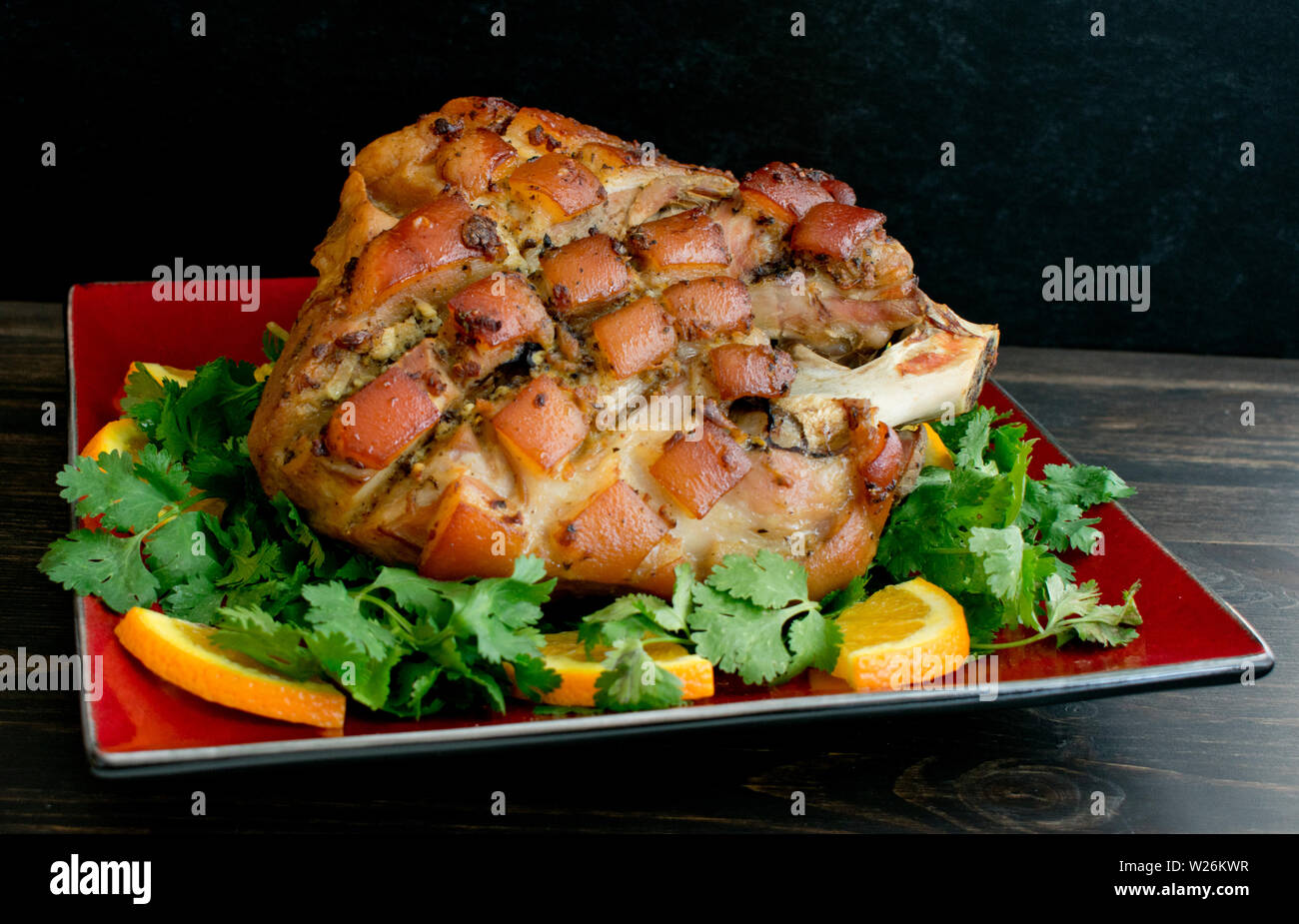 Pernil arrosto di maiale farcita con il coriandolo e arance Foto Stock