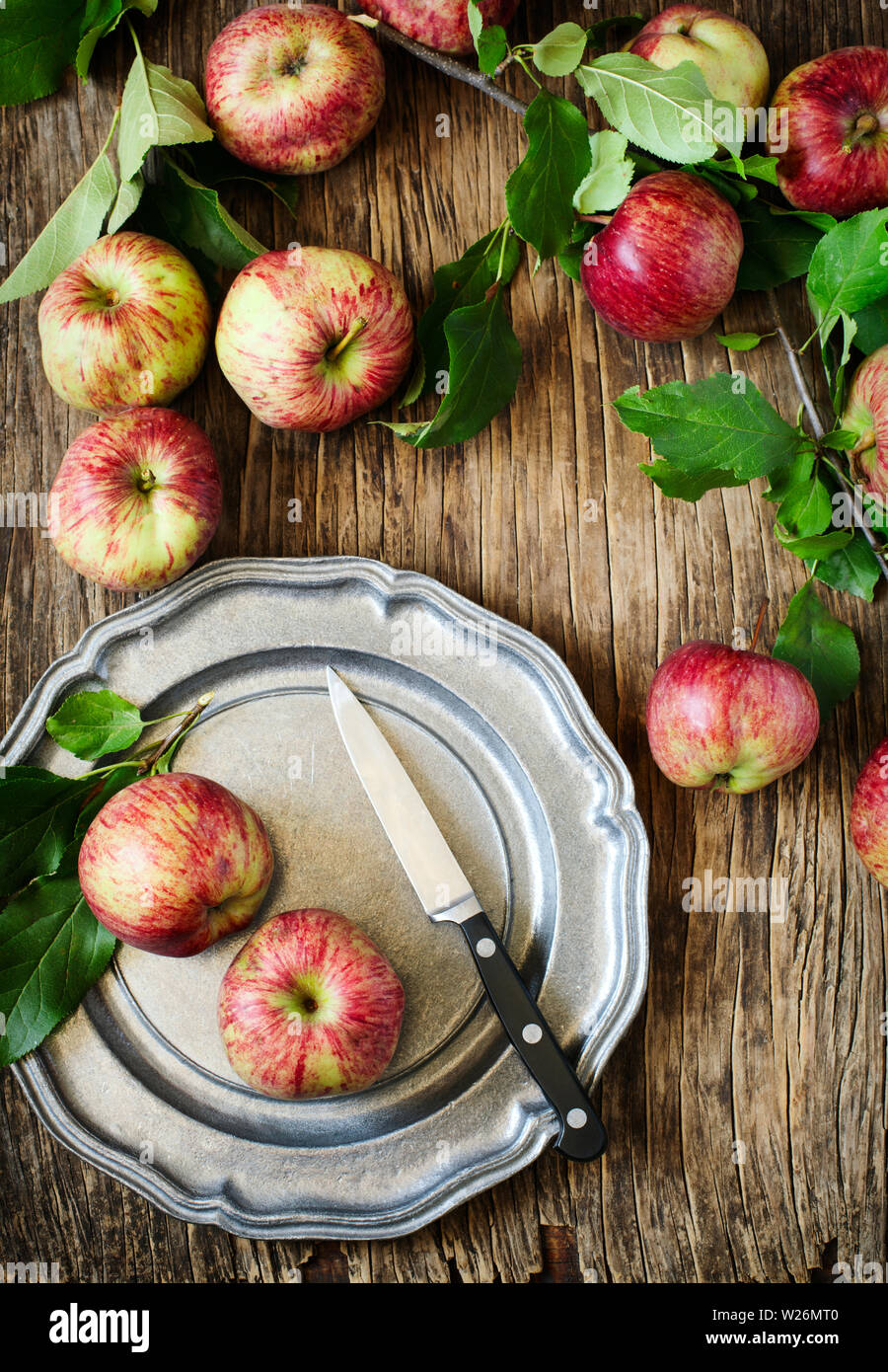 Mele con foglie su sfondo di legno, vista dall'alto Foto Stock