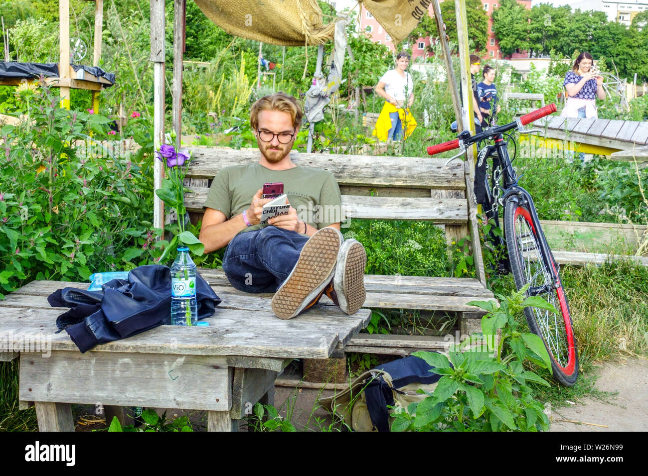Il giovane si gode in un giardino comunitario sul campo Tempelhof, Berlino-Neukölln, Germania giardino comunitario Europa Foto Stock