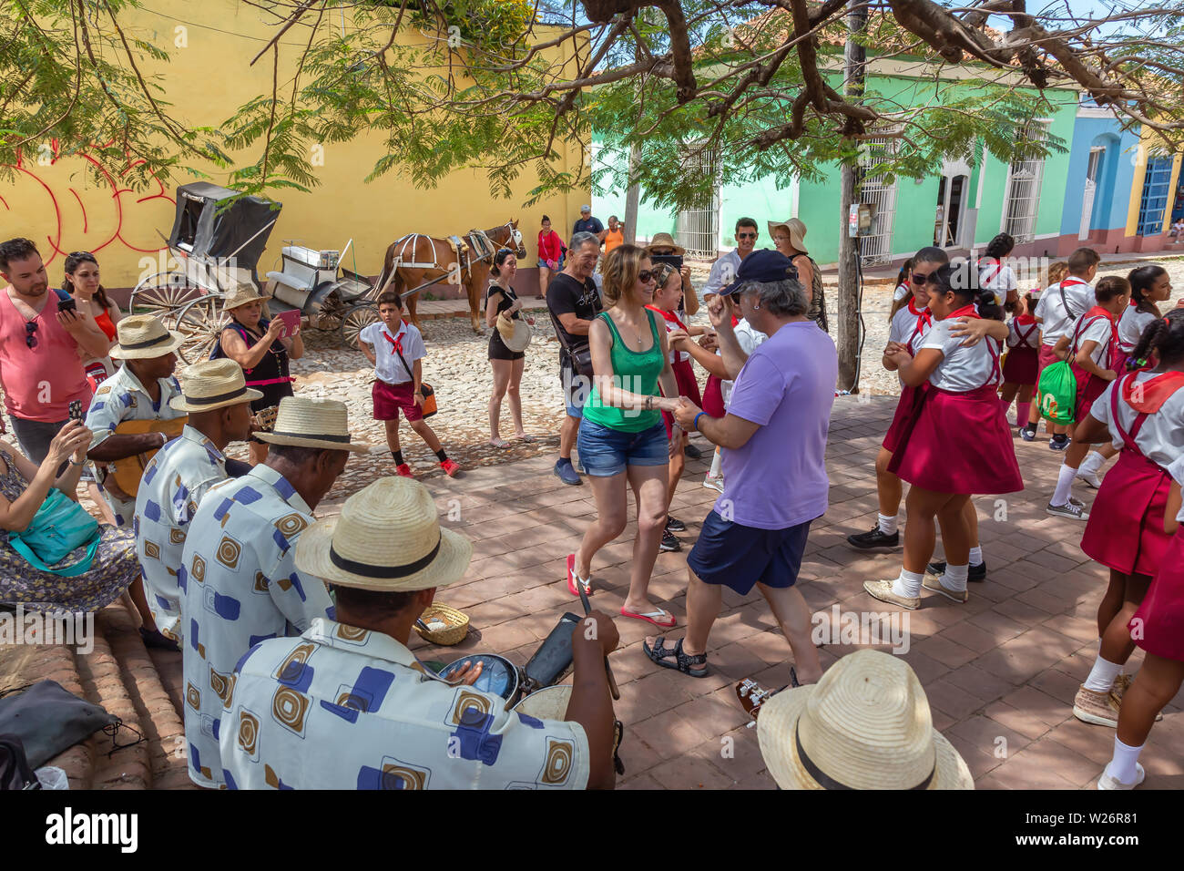 Trinidad, Cuba - Giugno 6, 2019: la gente ballare con la musica dal vivo per le strade di una piccola città cubane durante una vivace giornata di sole. Foto Stock