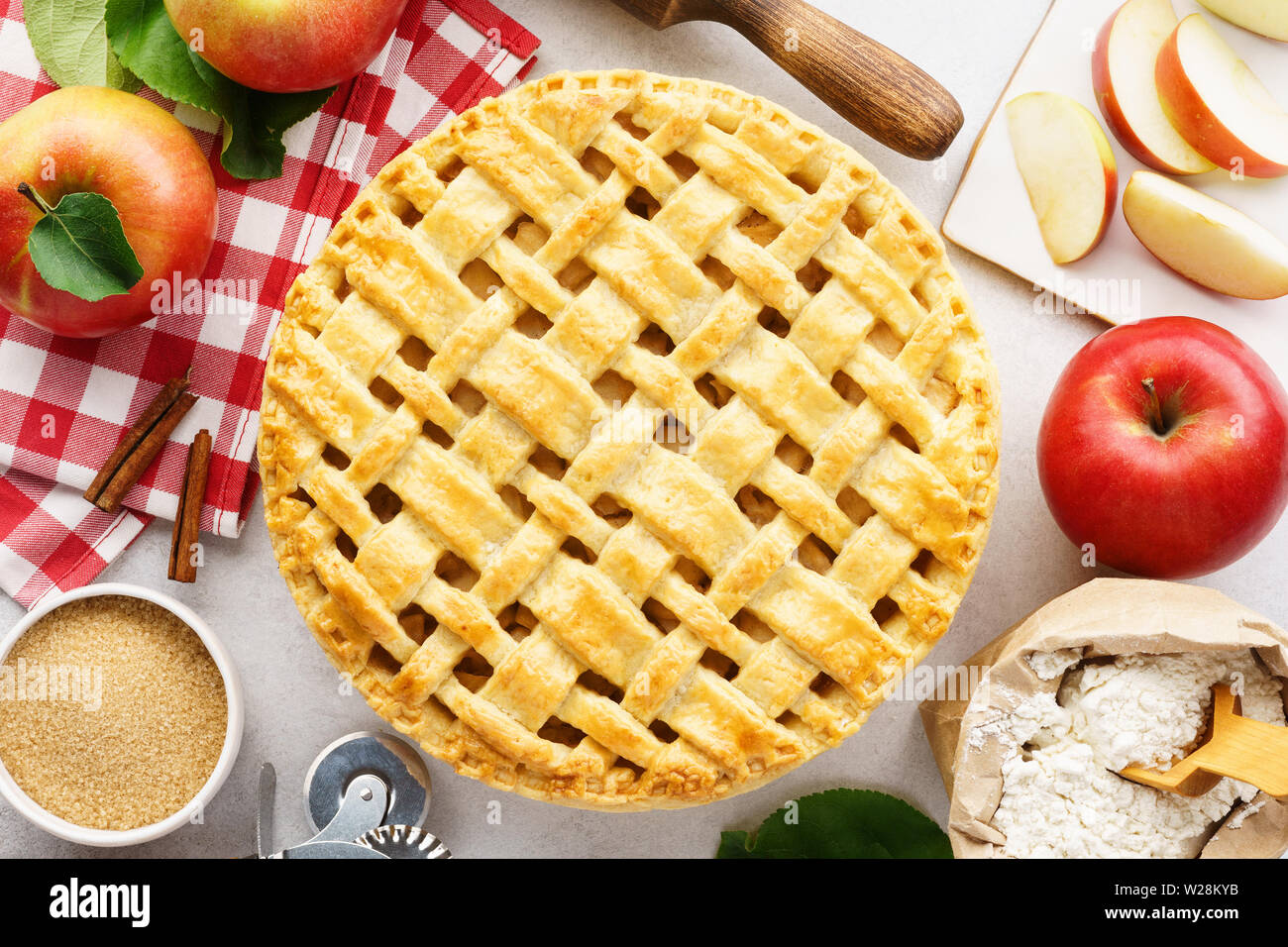 In casa la torta di mele con la parte superiore del reticolo e gli ingredienti per cucinare. Tradizionale American stagionale il concetto di pasticceria. Foto Stock