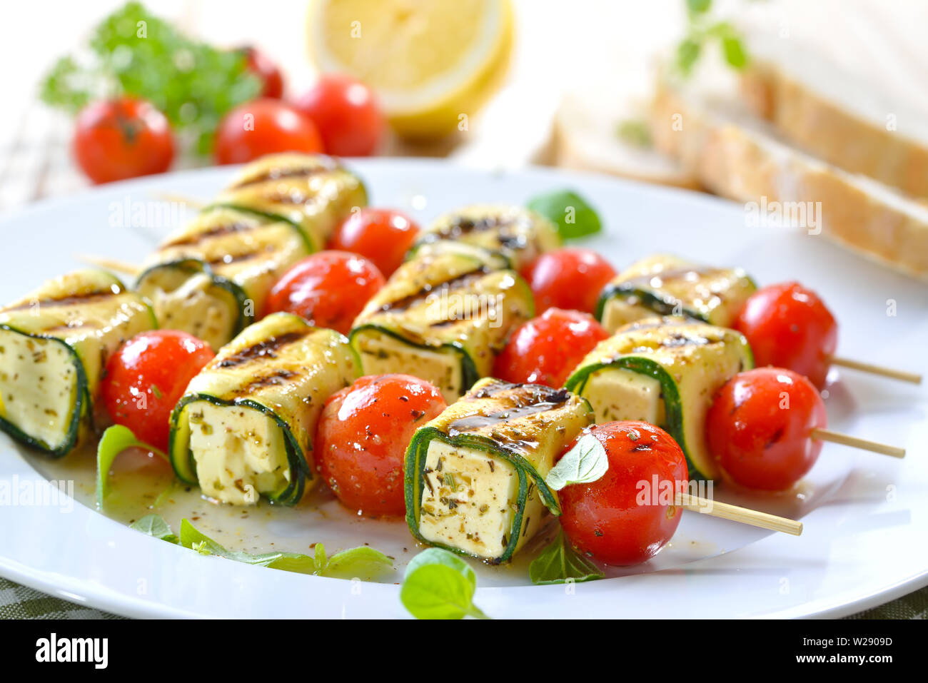 Pasto vegetariano: alla griglia marinati spiedini di feta con formaggio greco, zucchine, pomodori ciliegia e erbe aromatiche Foto Stock