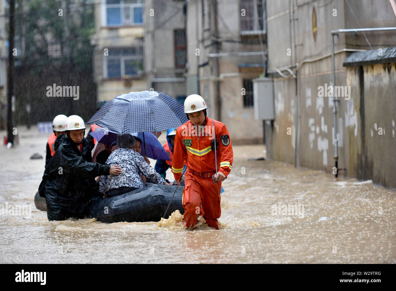 Il Fujian, Cina. 07 Luglio, 2019. I vigili del fuoco di residenti di salvataggio intrappolato in alluvione causata da una serie di intense precipitazioni in te contea di Sanming, a sud-est della Cina di provincia del Fujian, Luglio 7, 2019. Credito: Xinhua/Alamy Live News Foto Stock