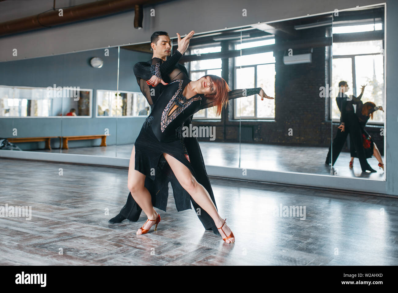 Due eleganza ballerini in costumi su ballrom danza di formazione in classe. Maschi e femmine di partner professionali sulla coppia danzante in studio Foto Stock