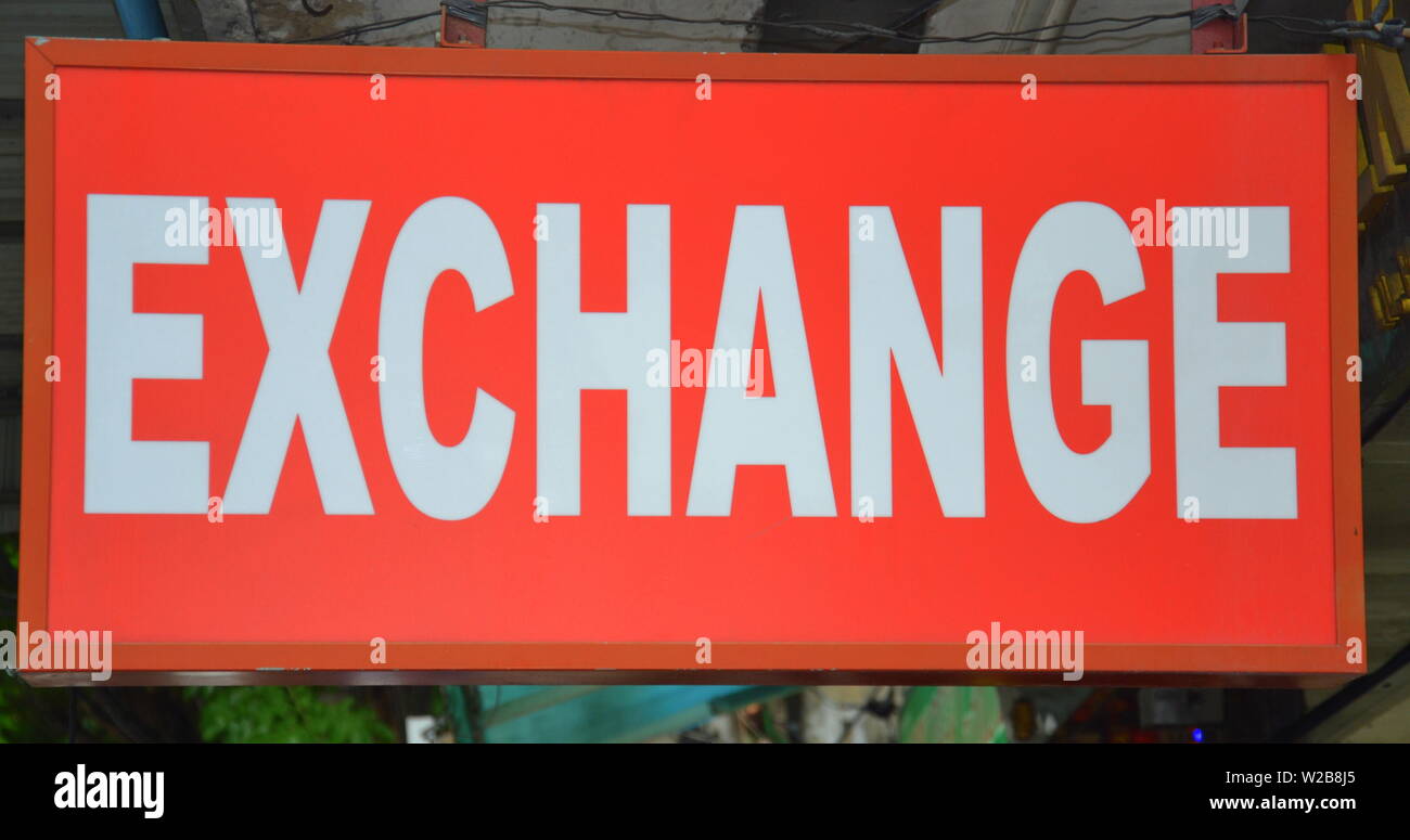 Un segno pubblicità a cambi di valuta estera servizio in Silom distretto turistico del centro di Bangkok, Thailandia Foto Stock
